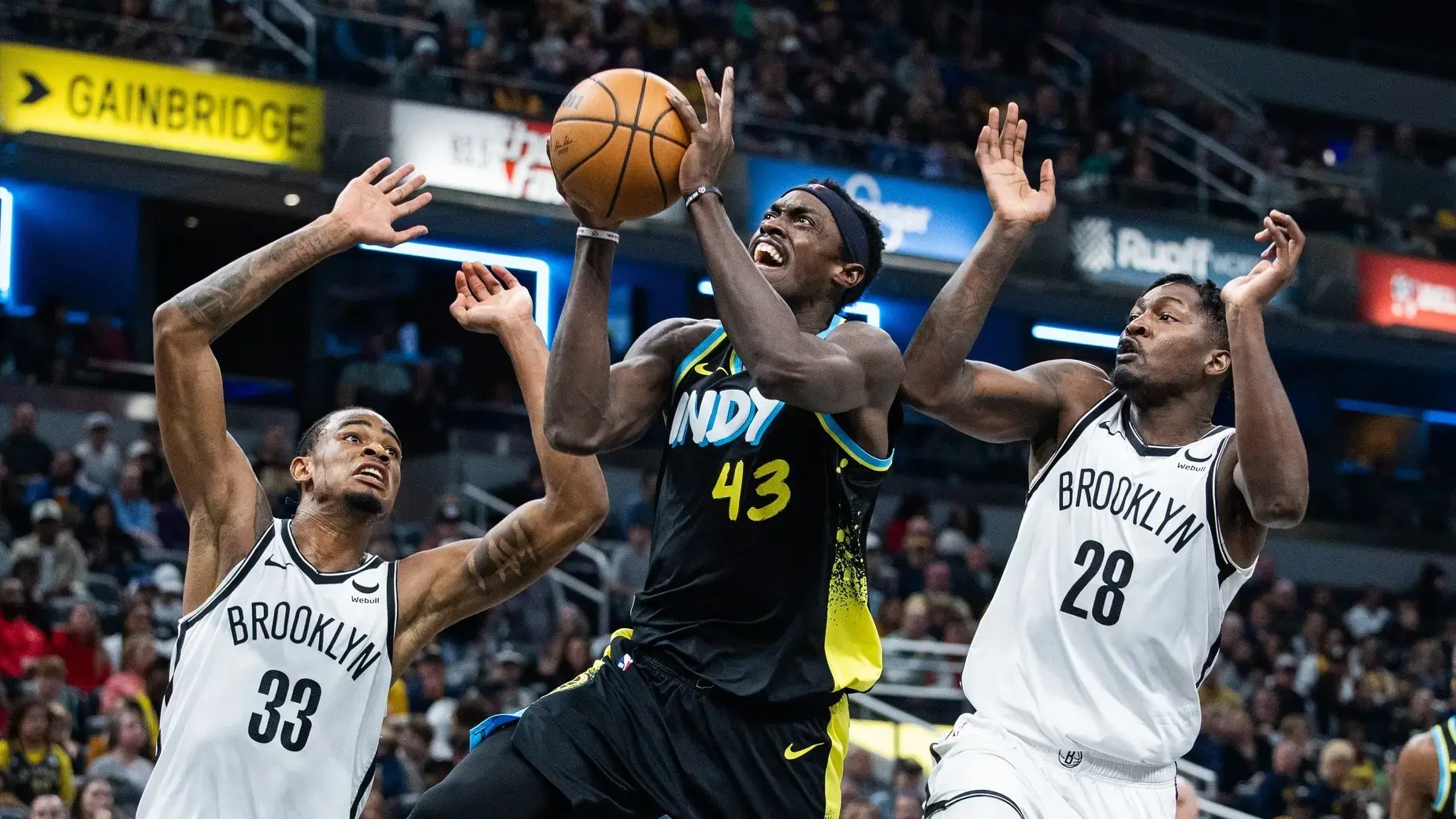 Indiana Pacers forward Pascal Siakam (43) shoots the ball while Brooklyn Nets center Nic Claxton (33) and forward Dorian Finney-Smith (28) defend in the first half at Gainbridge Fieldhouse. / Trevor Ruszkowski-USA TODAY Sports