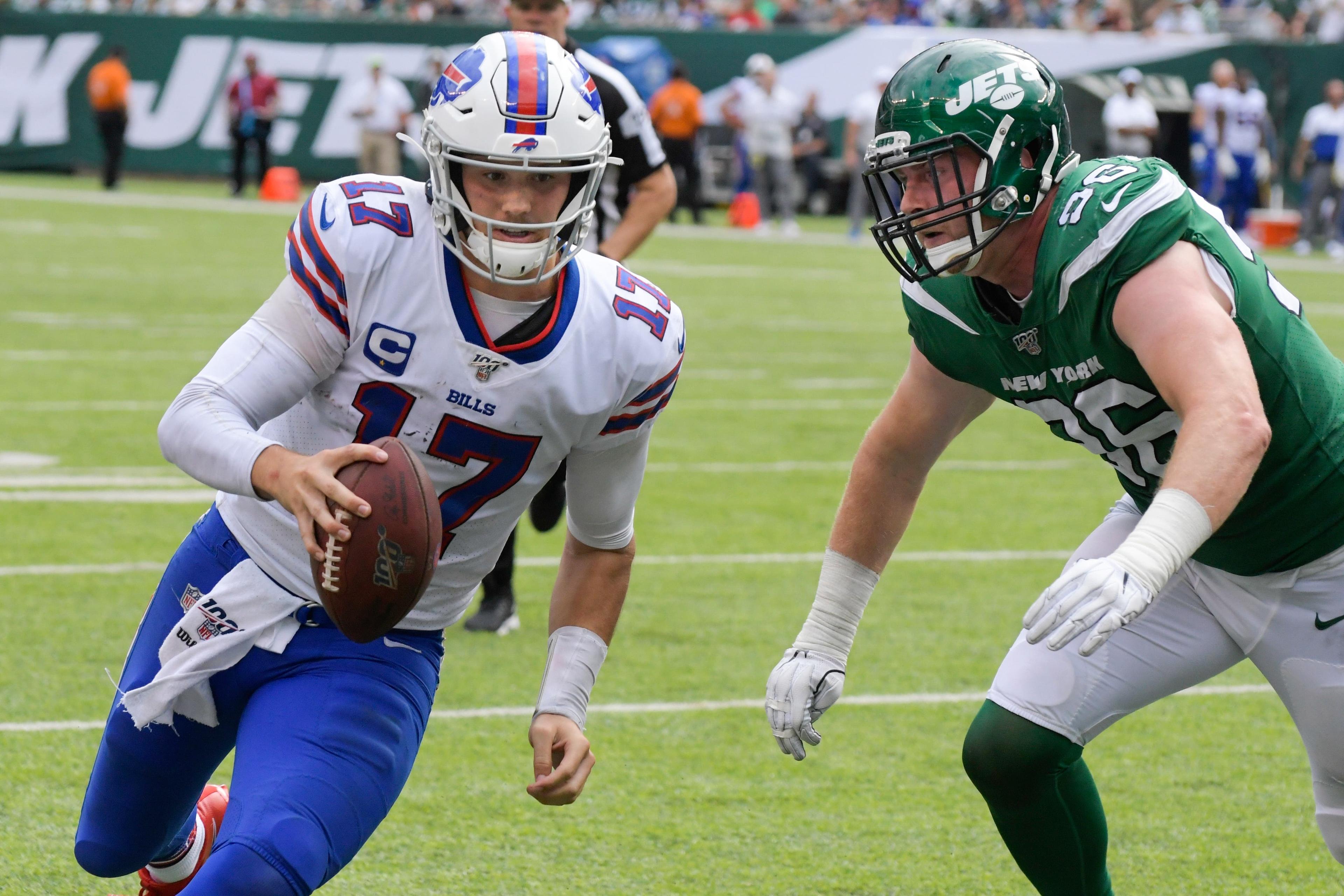 Buffalo Bills' Josh Allen (17) runs past New York Jets' Henry Anderson (96) for a touchdown during the second half of an NFL football game Sunday, Sept. 8, 2019, in East Rutherford, N.J. (AP Photo/Bill Kostroun) / Bill Kostroun/AP