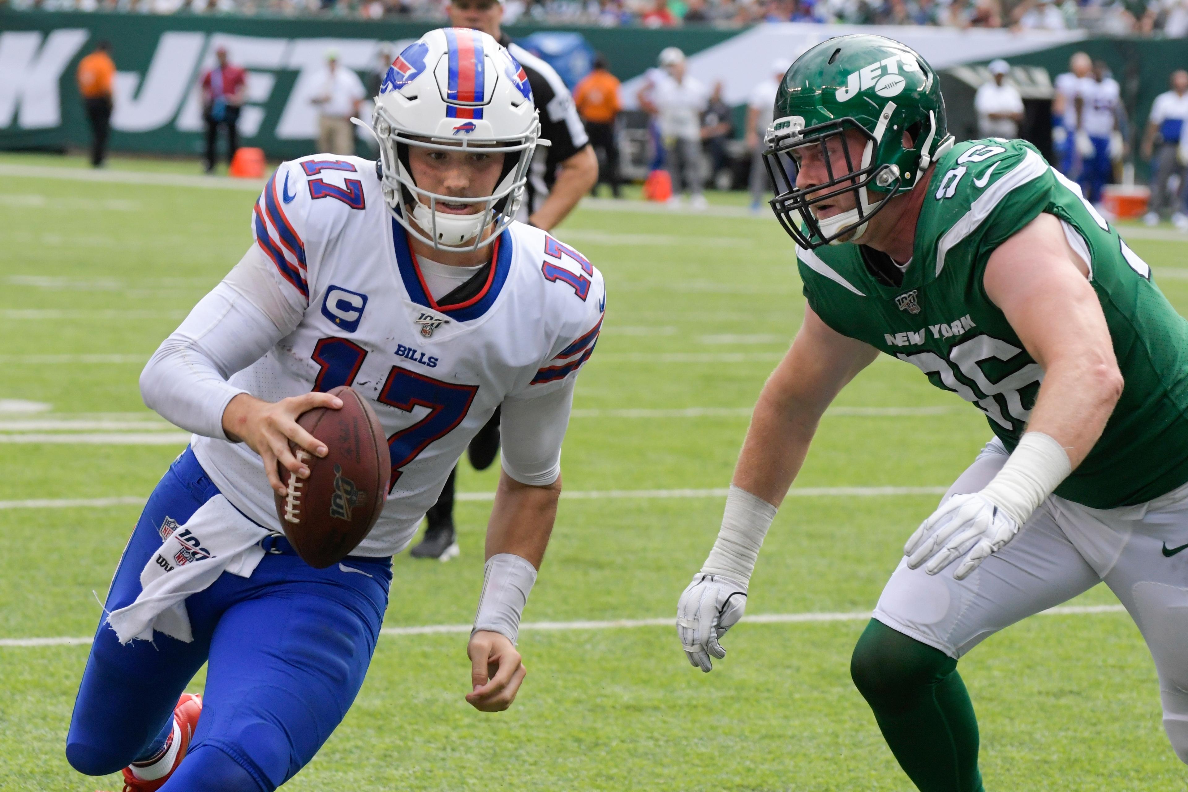 Buffalo Bills' Josh Allen (17) runs past New York Jets' Henry Anderson (96) for a touchdown during the second half of an NFL football game Sunday, Sept. 8, 2019, in East Rutherford, N.J. (AP Photo/Bill Kostroun)