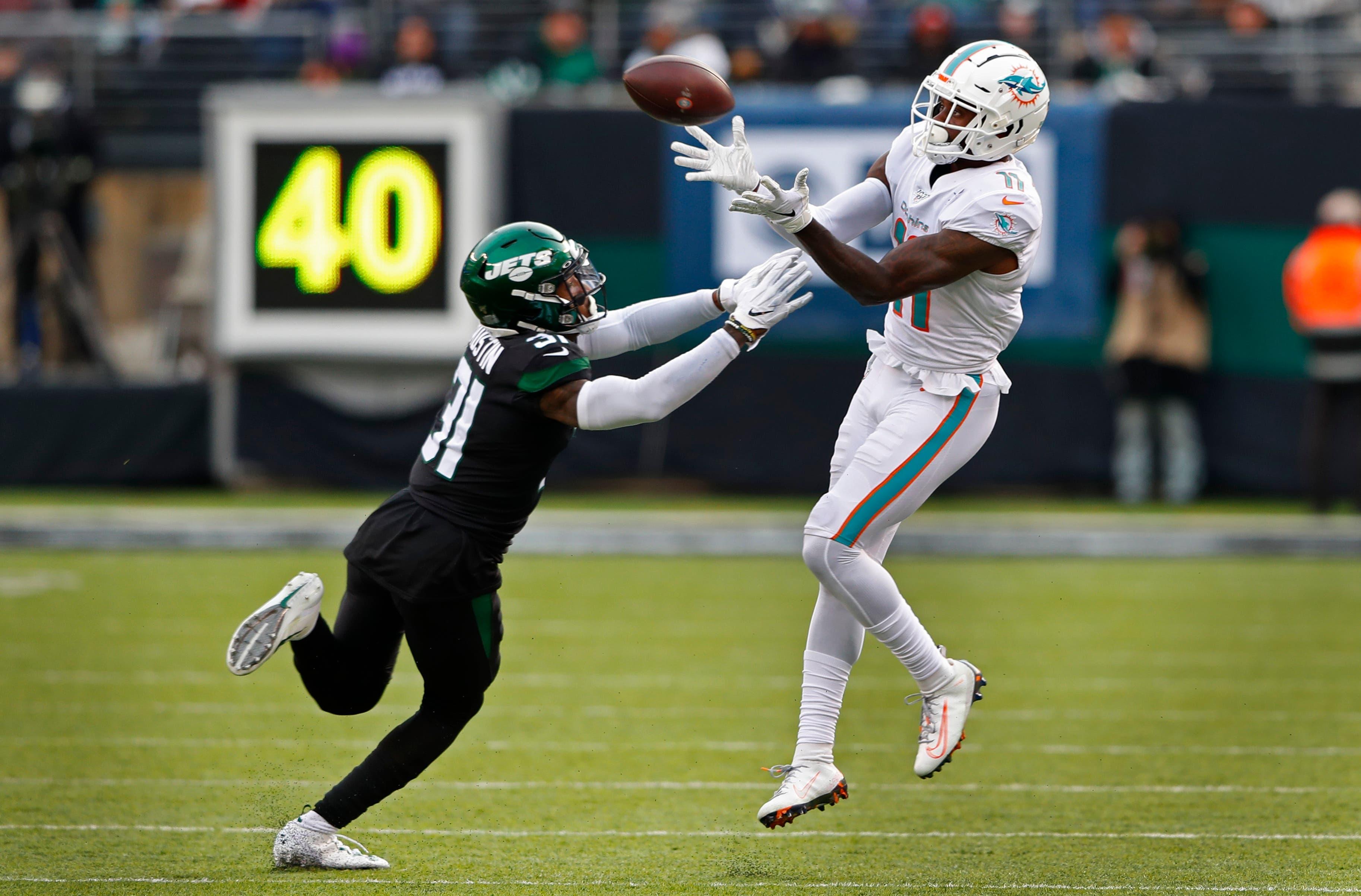 Dec 8, 2019; East Rutherford, NJ, USA; Miami Dolphins wide receiver DeVante Parker (11) makes a catch against New York Jets defensive back Blessuan Austin (31) during the first half at MetLife Stadium. Mandatory Credit: Noah K. Murray-USA TODAY Sports / Noah K. Murray