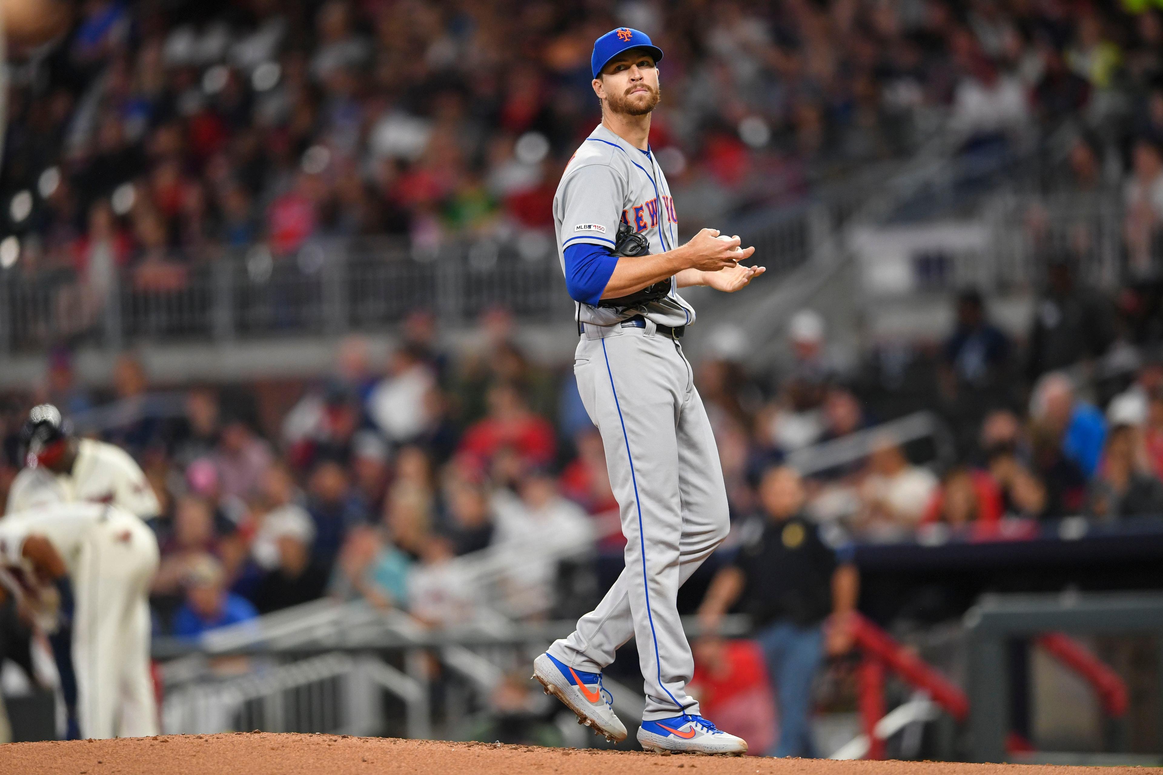 New York Mets starting pitcher Jacob deGrom reacts after walking a batter against the Atlanta Braves during the third inning at SunTrust Park. / Dale Zanine/USA TODAY Sports