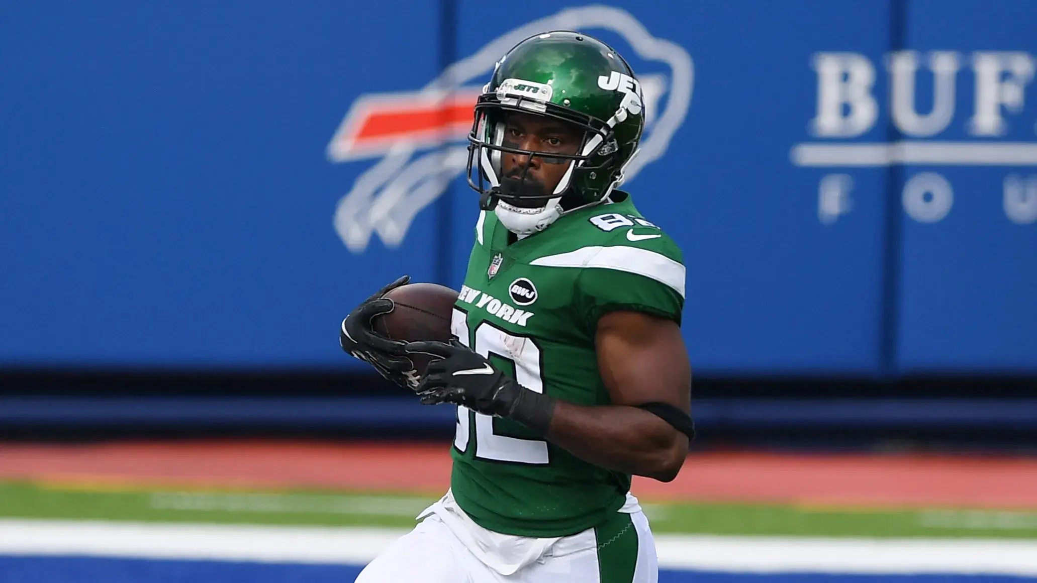 Sep 13, 2020; Orchard Park, New York, USA; New York Jets wide receiver Jamison Crowder (82) runs into the end zone for a touchdown in front of Buffalo Bills cornerback Taron Johnson (24) during the third quarter at Bills Stadium. / © Rich Barnes-USA TODAY Sports