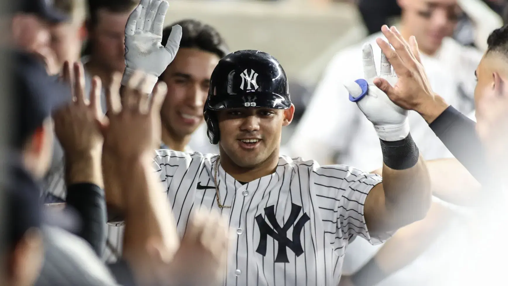 Sep 6, 2023; Bronx, New York, USA; New York Yankees center fielder Jasson Dominguez (89) is greeted in the dugout after hitting a solo home run in the third inning against the Detroit Tigers at Yankee Stadium. / Wendell Cruz-USA TODAY Sports