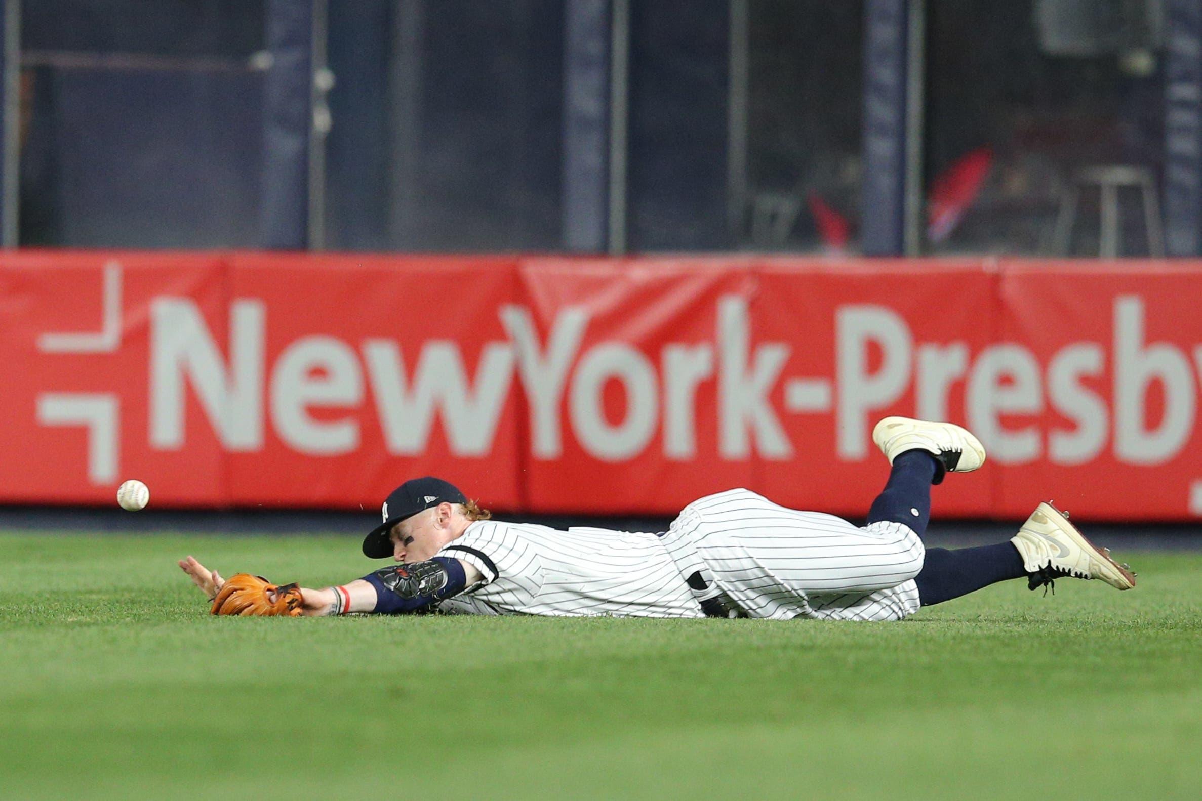 New York Yankees right fielder Clint Frazier dives for but cannot catch an RBI single by Boston Red Sox left fielder Andrew Benintendi during the seventh inning at Yankee Stadium. / Brad Penner/USA TODAY Sports