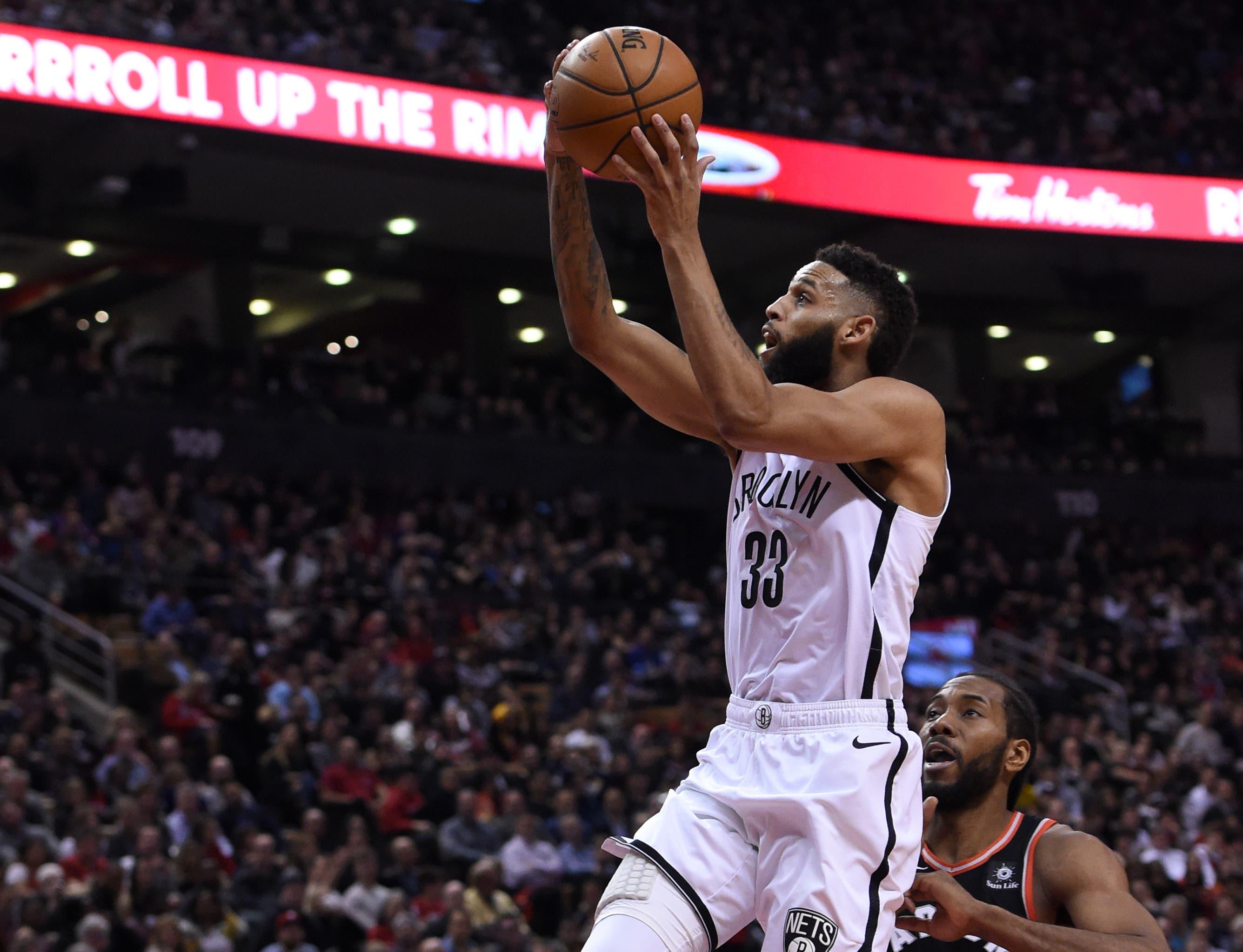 Brooklyn Nets forward Allen Crabbe shoots for a basket over Toronto Raptors forward Kawhi Leonard in the second half at Scotiabank Arena. / Dan Hamilton/USA TODAY Sports