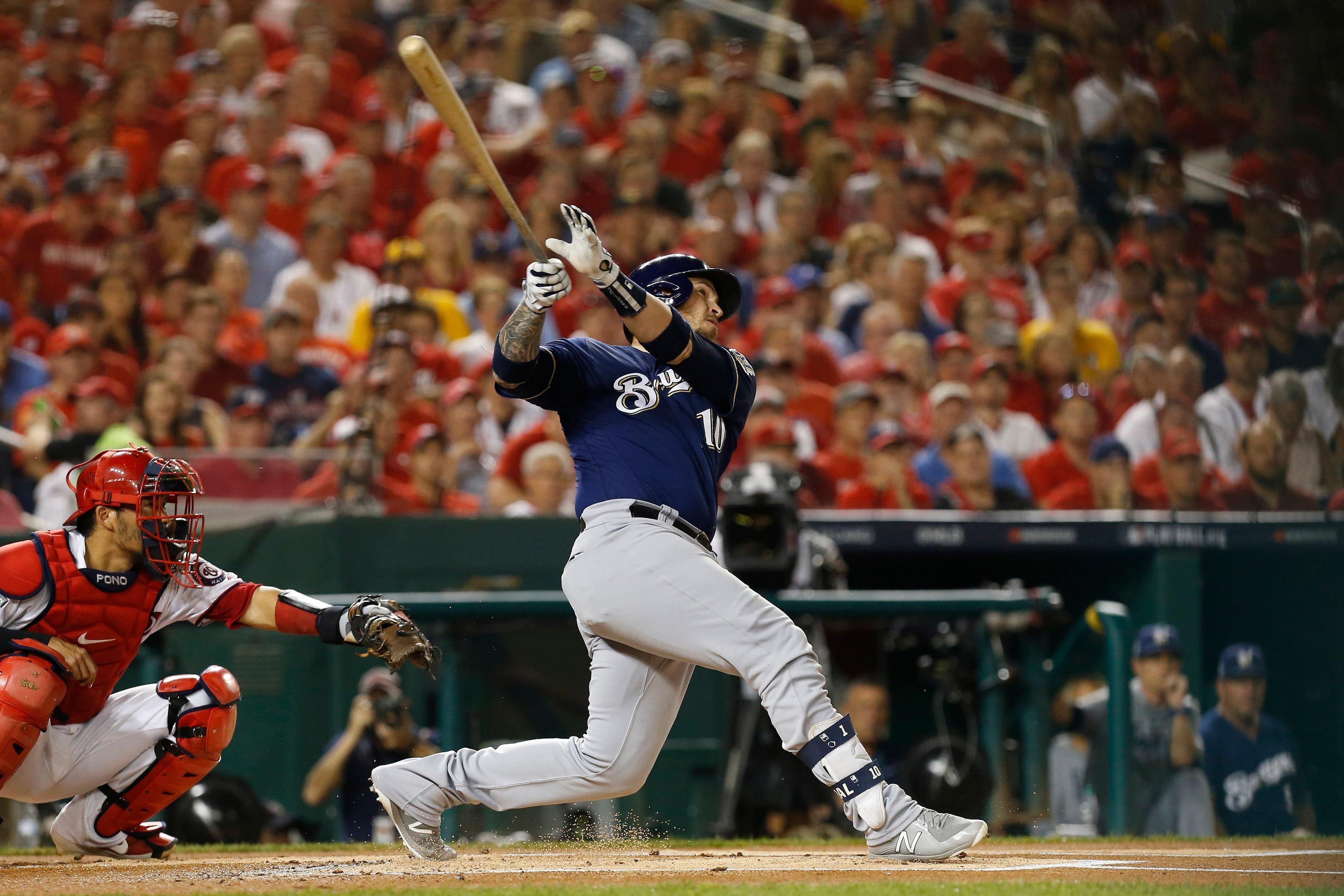 Oct 1, 2019; Washington, DC, USA; Milwaukee Brewers catcher Yasmani Grandal (10) hits a two run home run during the first inning against the Washington Nationals in the 2019 National League Wild Card playoff baseball game at Nationals Park. Mandatory Credit: Geoff Burke-USA TODAY Sports / Geoff Burke