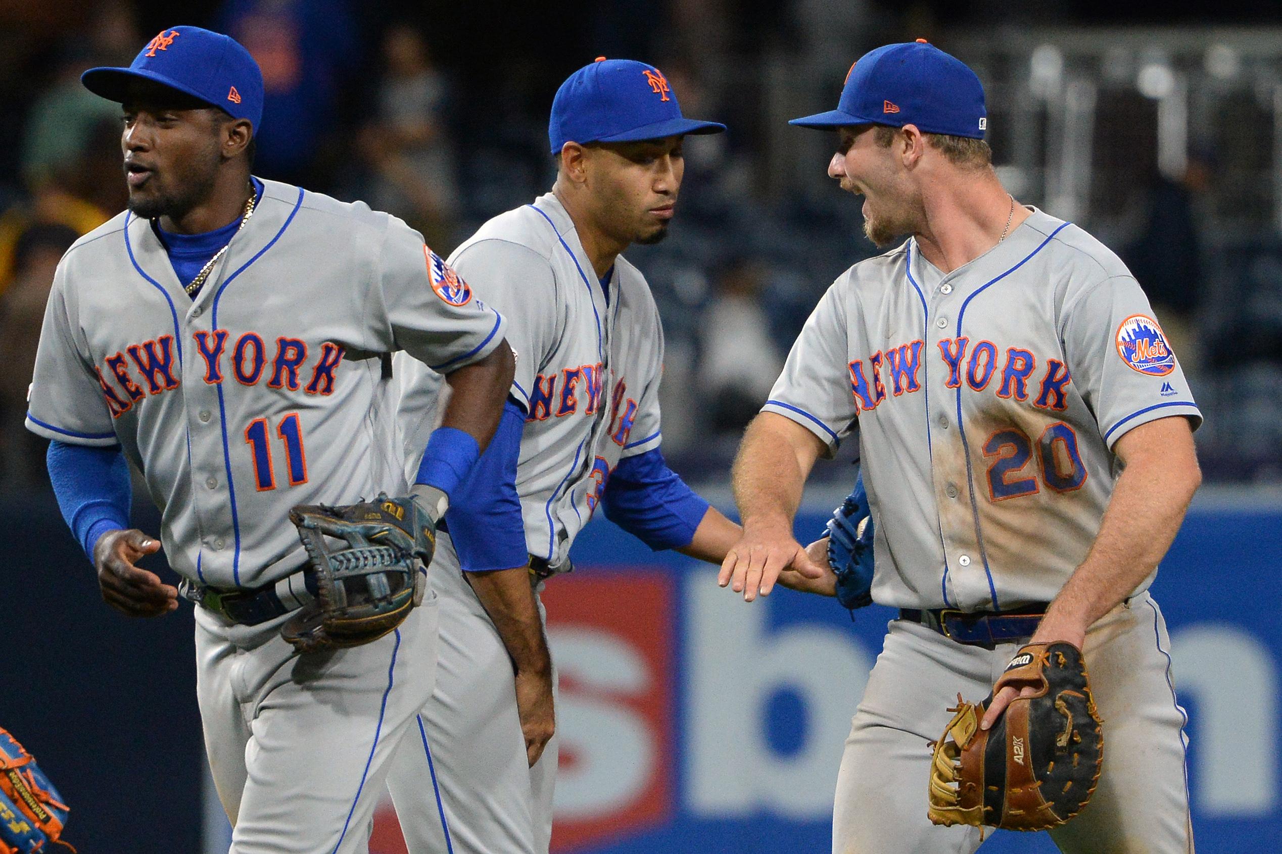 May 7, 2019; San Diego, CA, USA; New York Mets first baseman Pete Alonso (20) and shortstop Adeiny Hechavarria (11) and relief pitcher Edwin Diaz (middle) celebrate after defeating the San Diego Padres at Petco Park. Mandatory Credit: Jake Roth-USA TODAY Sports