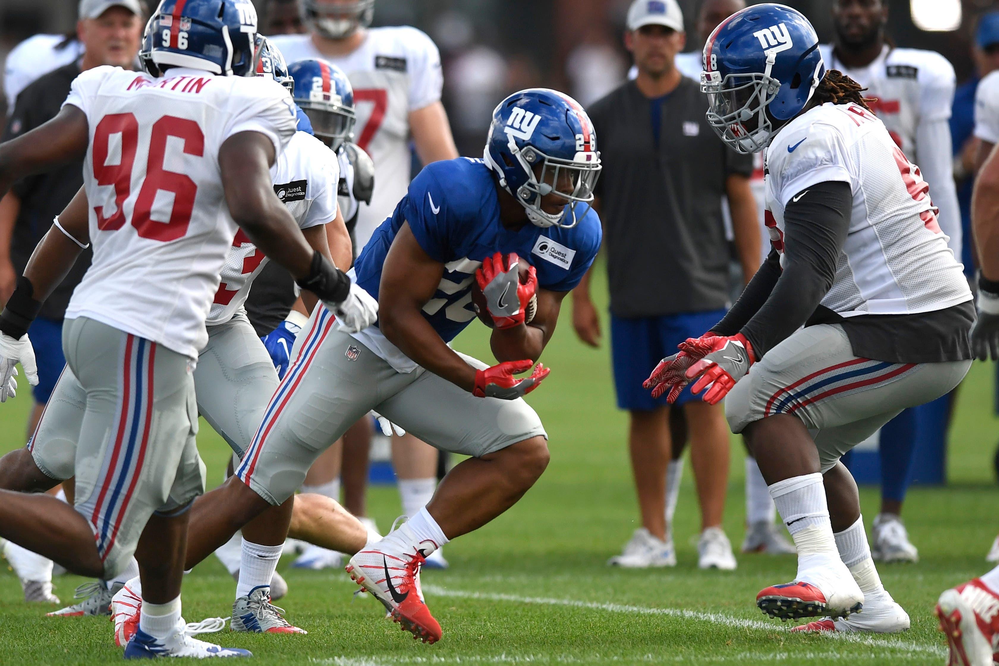 Aug 1, 2018; East Rutherford, NJ, USA; New York Giants running back Saquon Barkley (26) rushes during training camp in East Rutherford. Mandatory Credit: Danielle Parhizkaran/NorthJersey.com via USA TODAY NETWORK / Danielle Parhizkaran