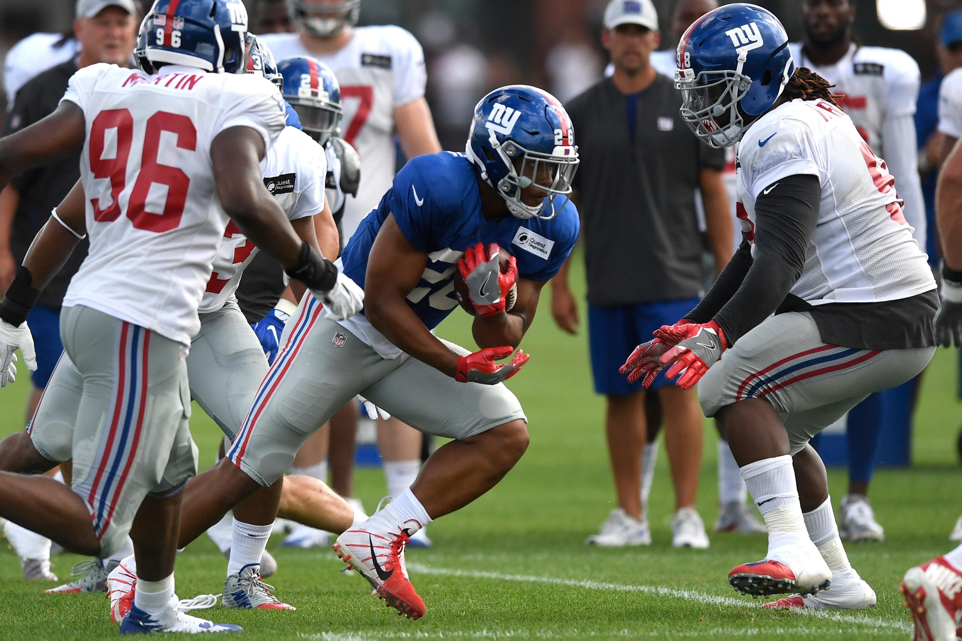 Aug 1, 2018; East Rutherford, NJ, USA; New York Giants running back Saquon Barkley (26) rushes during training camp in East Rutherford. Mandatory Credit: Danielle Parhizkaran/NorthJersey.com via USA TODAY NETWORK