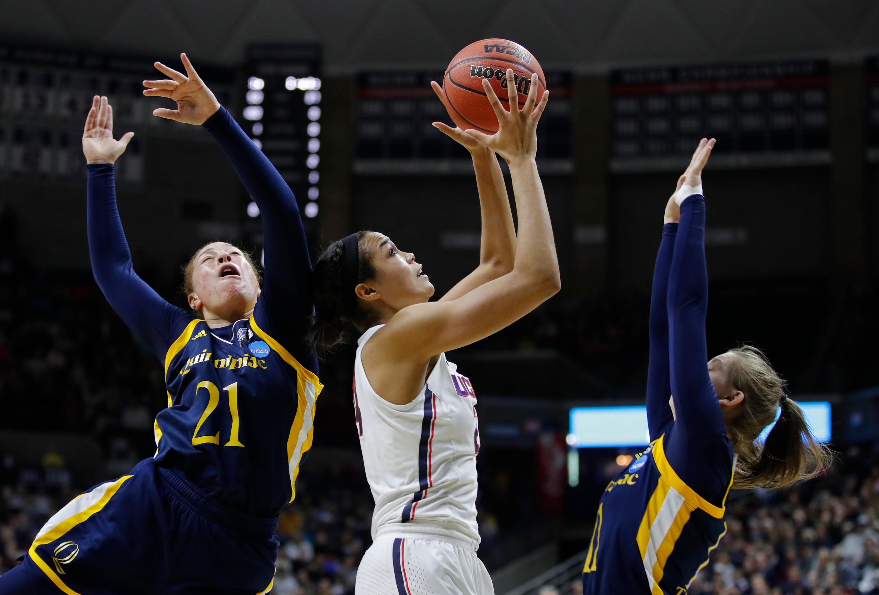 Connecticut Huskies forward Napheesa Collier attempts to control the ball as Quinnipiac Bobcats forward Jen Fay and guard Edel Thornton defend in the first half of the women's NCAA tournament second round at Gampel Pavilion.