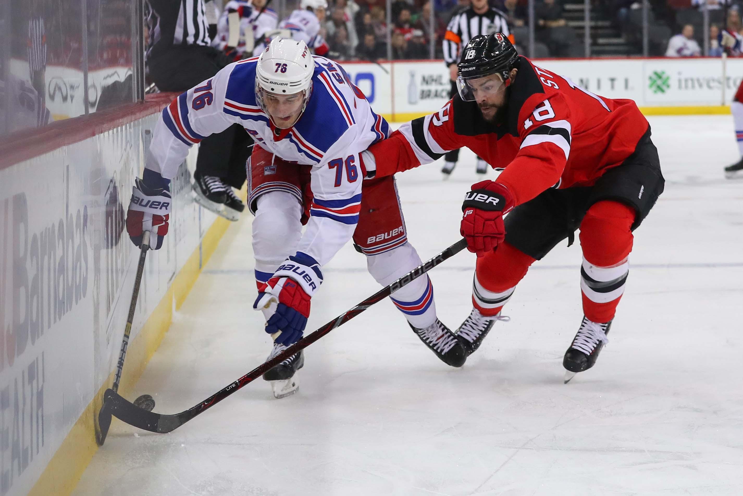 New York Rangers defenseman Brady Skjei and New Jersey Devils right wing Drew Stafford battle for the puck during the first period at Prudential Center. / Ed Mulholland/USA TODAY Sports