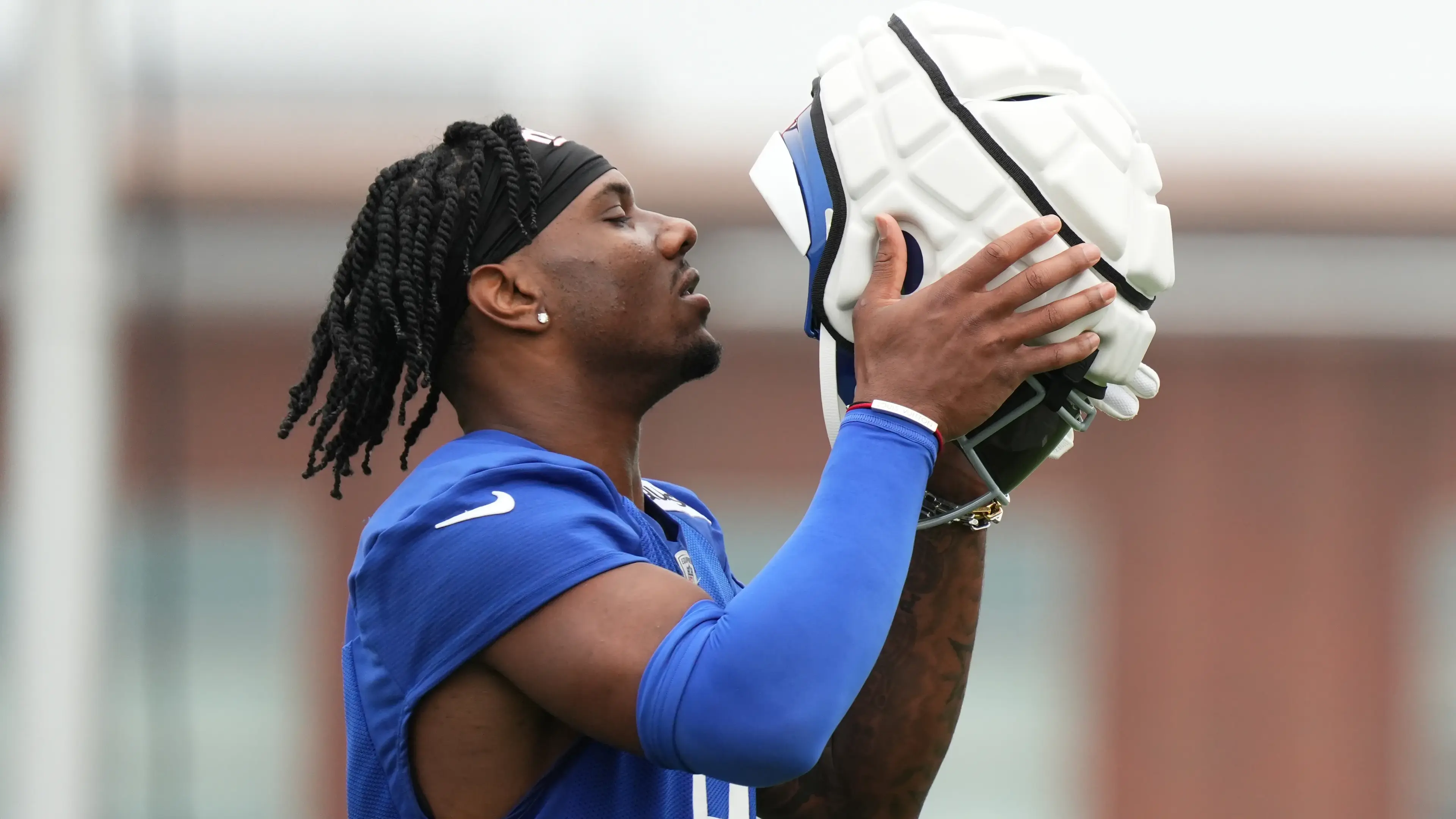 East Rutherford, NY, USA; New York Giants wide receiver Malik Nabers (9) puts on his helmet during training camp at Quest Diagnostics Training Center. / Lucas Boland - USA TODAY Sports