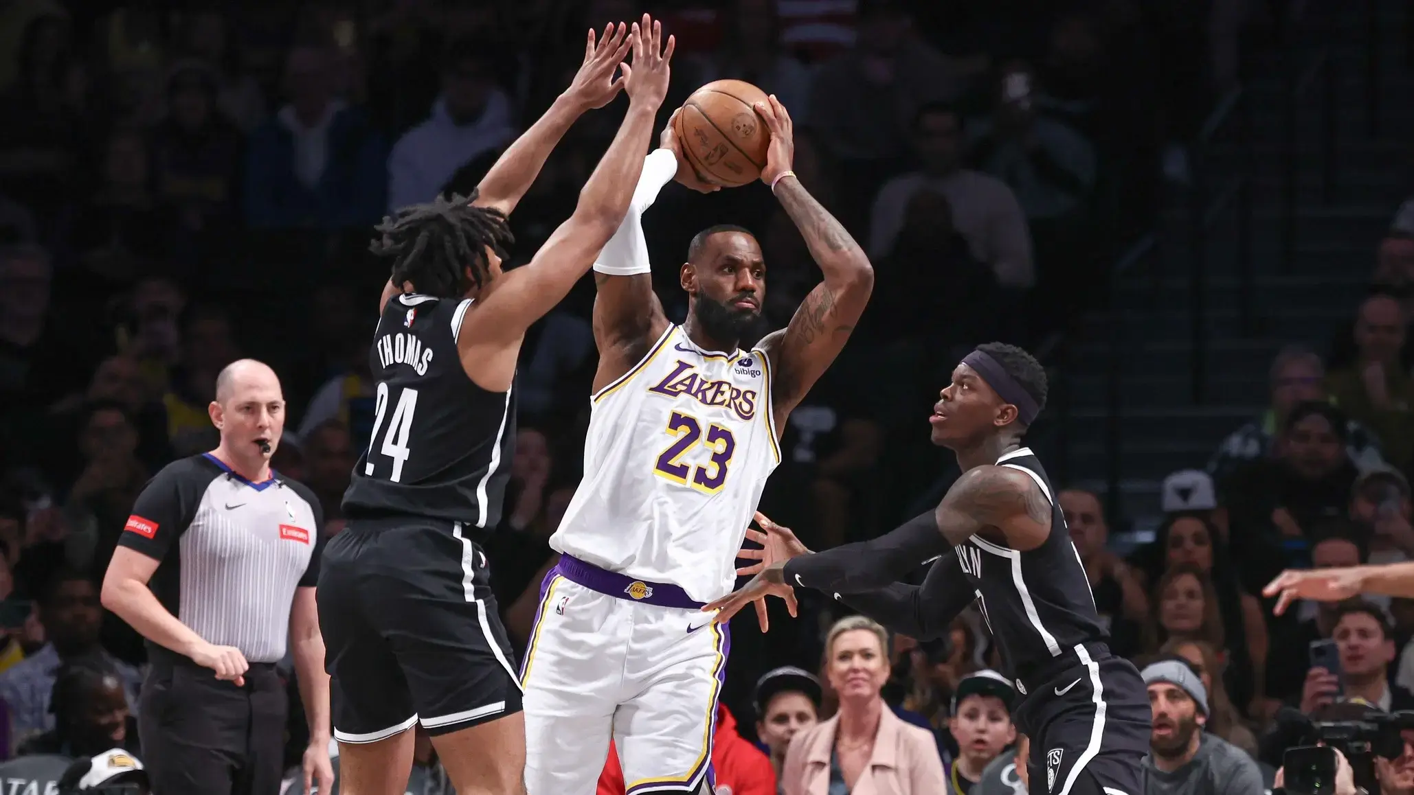 Los Angeles Lakers forward LeBron James (23) looks to pass as Brooklyn Nets guard Cam Thomas (24) and guard Dennis Schroder (17) defend during the first quarter at Barclays Center. / Vincent Carchietta-USA TODAY Sports