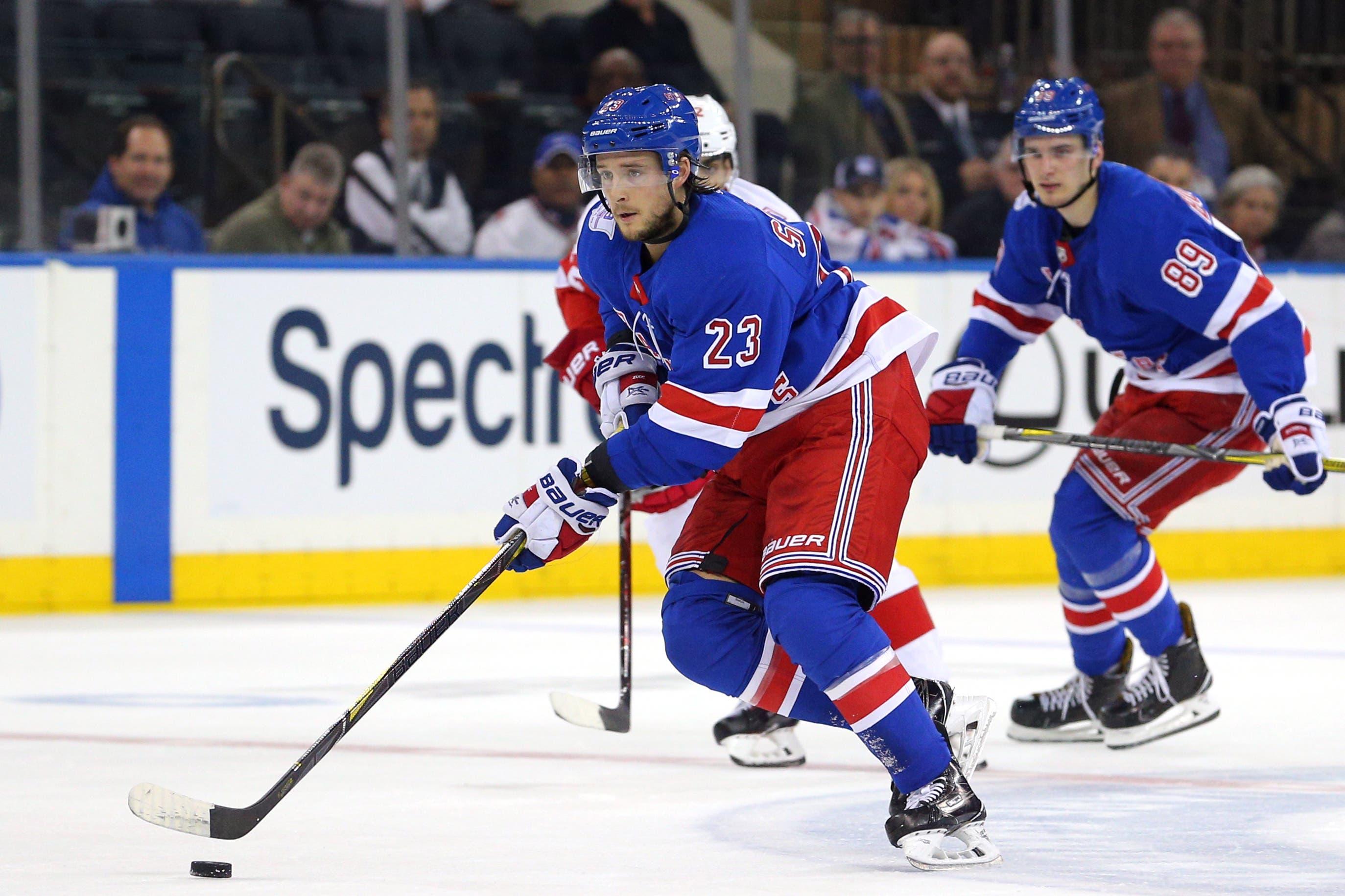 Feb 25, 2018; New York, NY, USA; New York Rangers center Ryan Spooner (23) plays the puck against the Detroit Red Wings during the overtime period at Madison Square Garden. Mandatory Credit: Brad Penner-USA TODAY Sports / Brad Penner