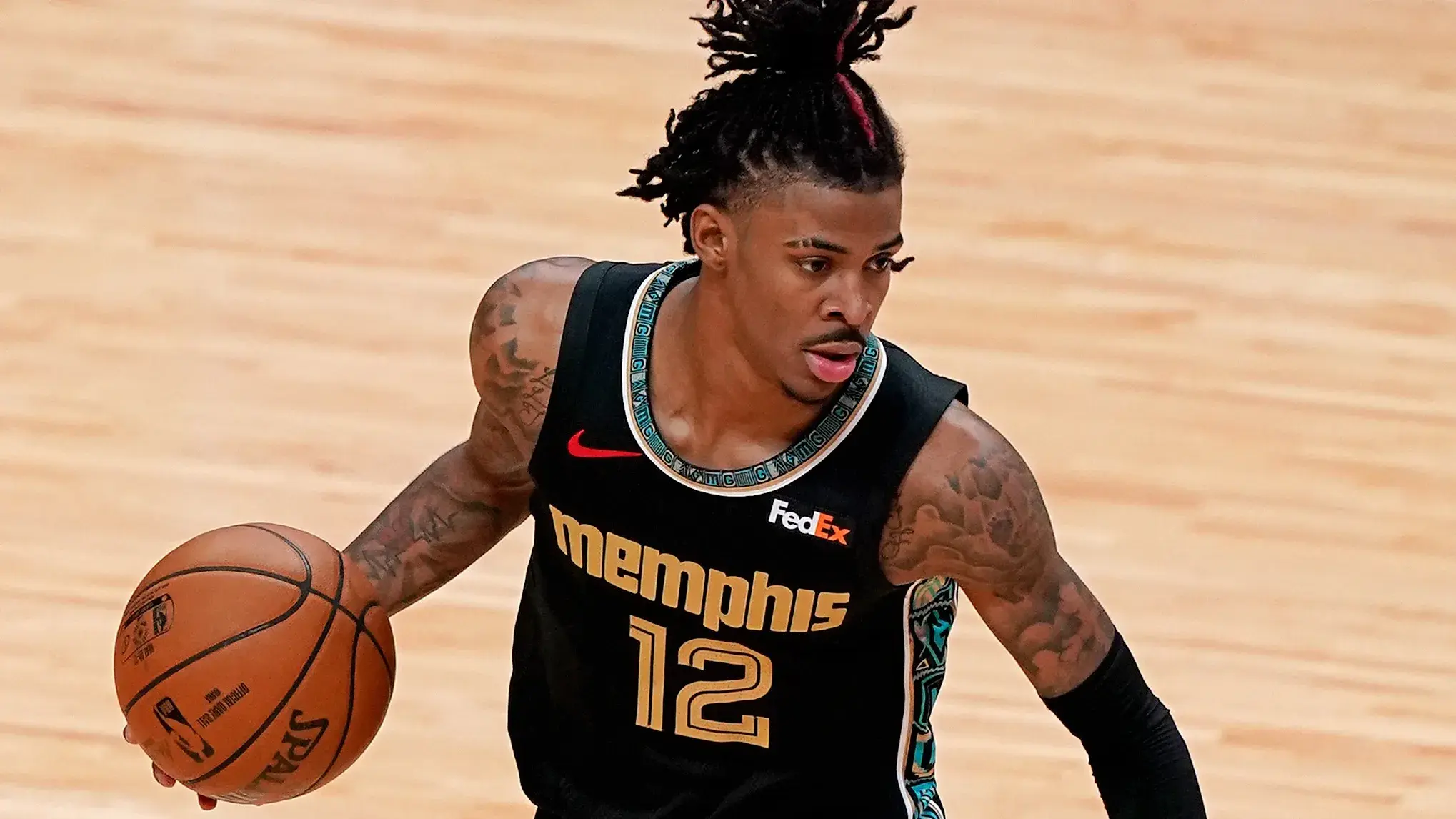 Apr 6, 2021; Miami, Florida, USA; Memphis Grizzlies guard Ja Morant (12) dribbles the ball against the Miami Heat during the second half at American Airlines Arena. / © Jasen Vinlove-USA TODAY Sports