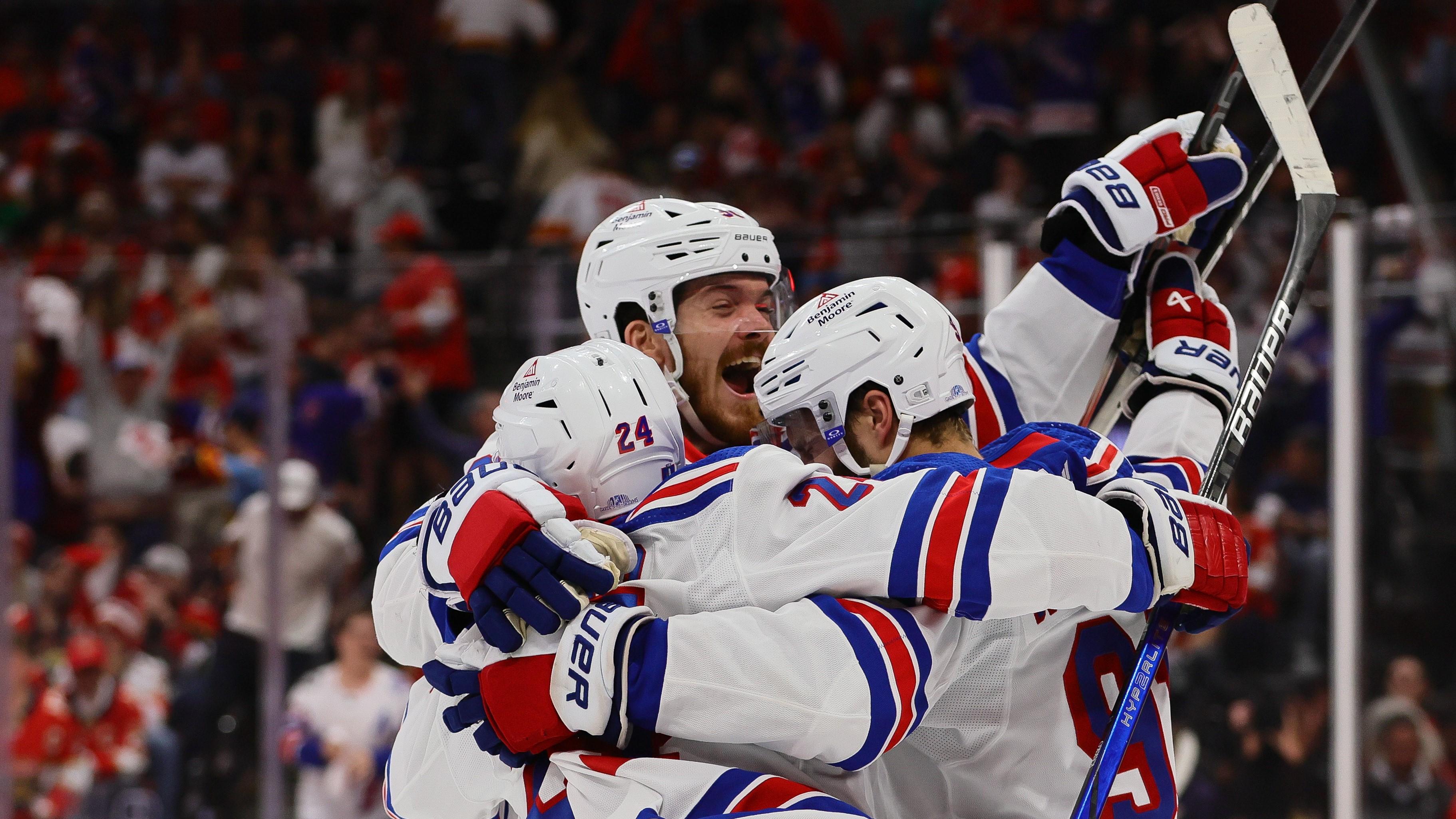 May 26, 2024; Sunrise, Florida, USA; New York Rangers center Alex Wennberg (91) celebrates with center Jack Roslovic (96) and right wing Kaapo Kakko (24) after scoring the game-winning goal in overtime against the Florida Panthers in game three of the Eastern Conference Final of the 2024 Stanley Cup Playoffs at Amerant Bank Arena. Mandatory Credit: Sam Navarro-USA TODAY Sports / © Sam Navarro-USA TODAY Sports