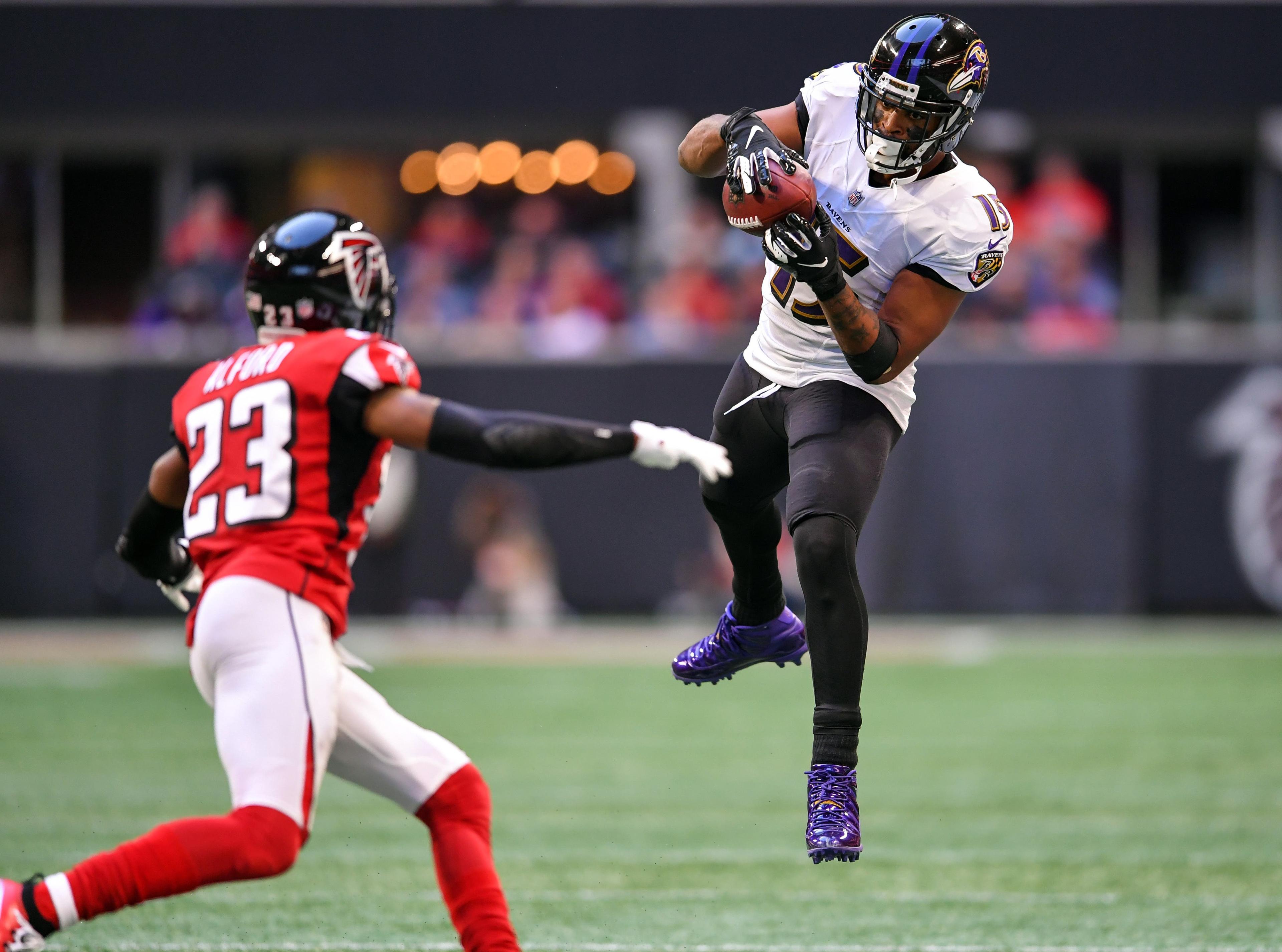 Dec 2, 2018; Atlanta, GA, USA; Baltimore Ravens wide receiver Michael Crabtree (15) makes a catch in front of Atlanta Falcons cornerback Robert Alford (23) during the second half at Mercedes-Benz Stadium. Mandatory Credit: Dale Zanine-USA TODAY Sports / Dale Zanine