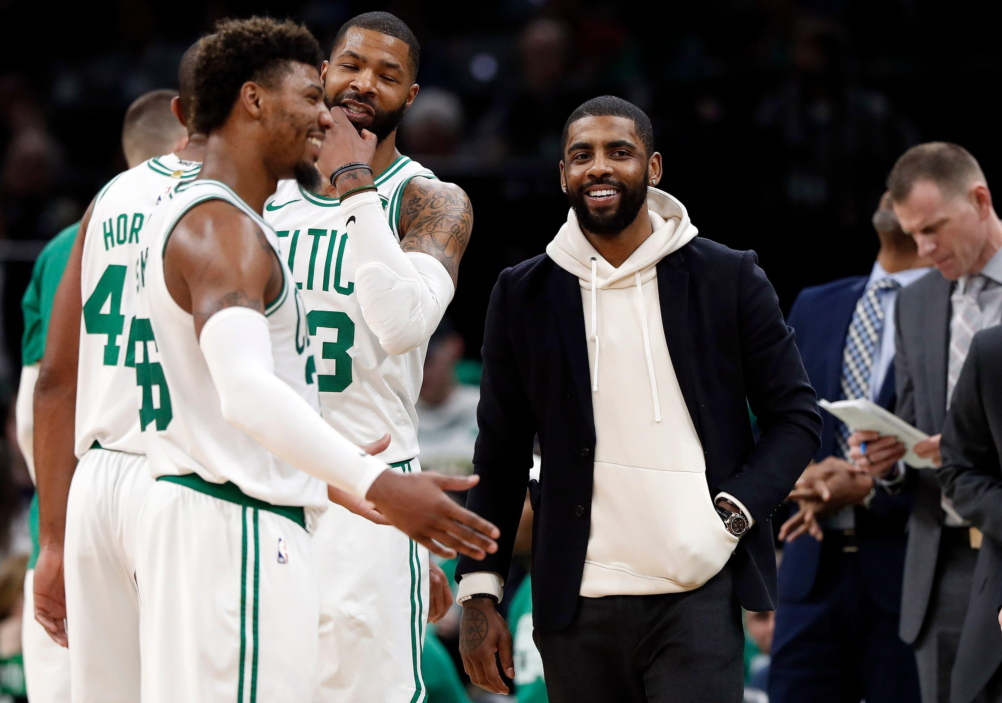 Feb 13, 2019; Boston, MA, USA; Dressed in street clothes, Boston Celtics guard Kyrie Irving (11) has a laugh with guard Marcus Smart (36) during the second half against the Detroit Pistons at TD Garden. Mandatory Credit: Winslow Townson-USA TODAY Sports / Winslow Townson