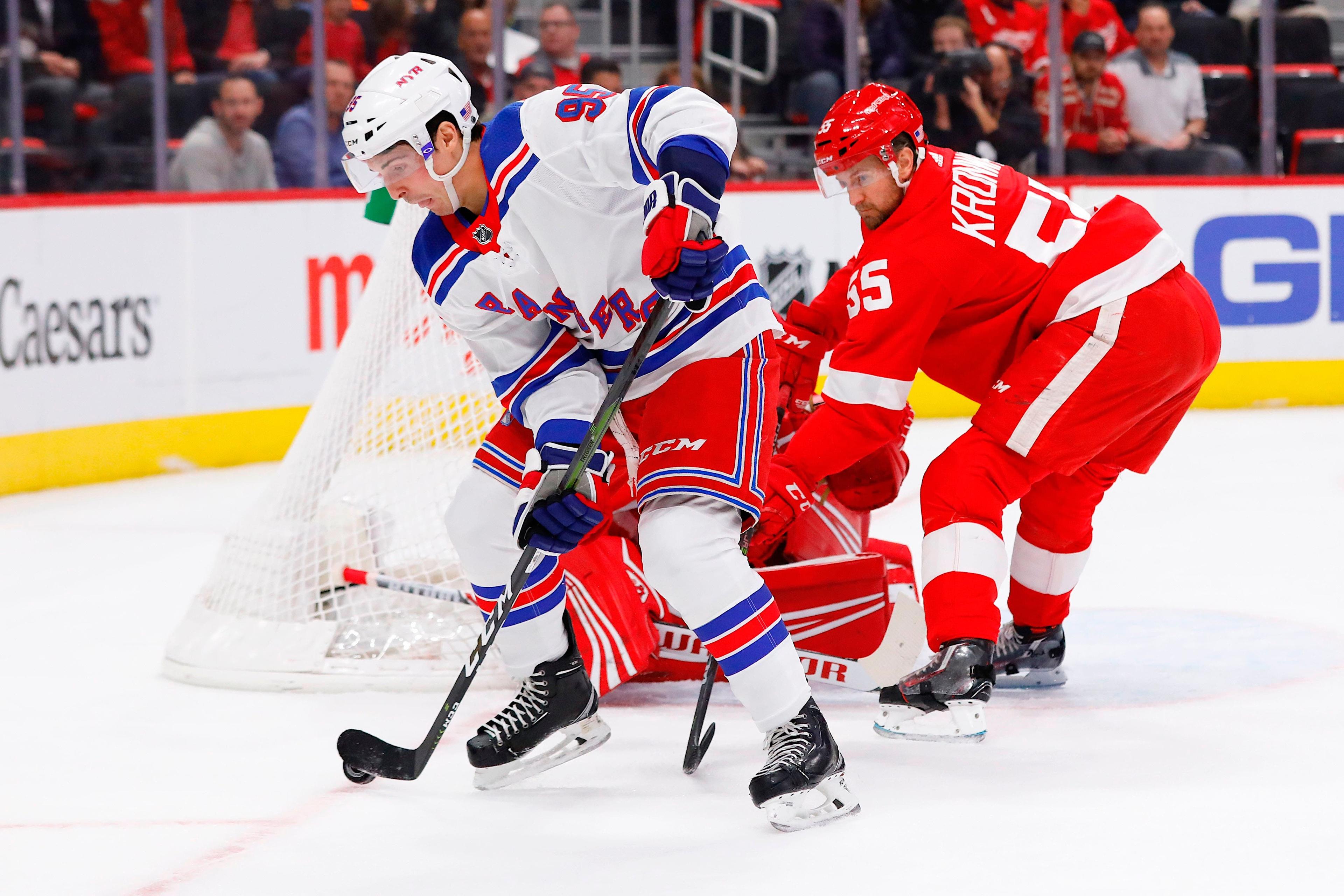 Nov 9, 2018; Detroit, MI, USA; New York Rangers center Vinni Lettieri (95) skates with the puck defended by Detroit Red Wings defenseman Niklas Kronwall (55) in the first period at Little Caesars Arena. Mandatory Credit: Rick Osentoski-USA TODAY SPORTS / Rick Osentoski