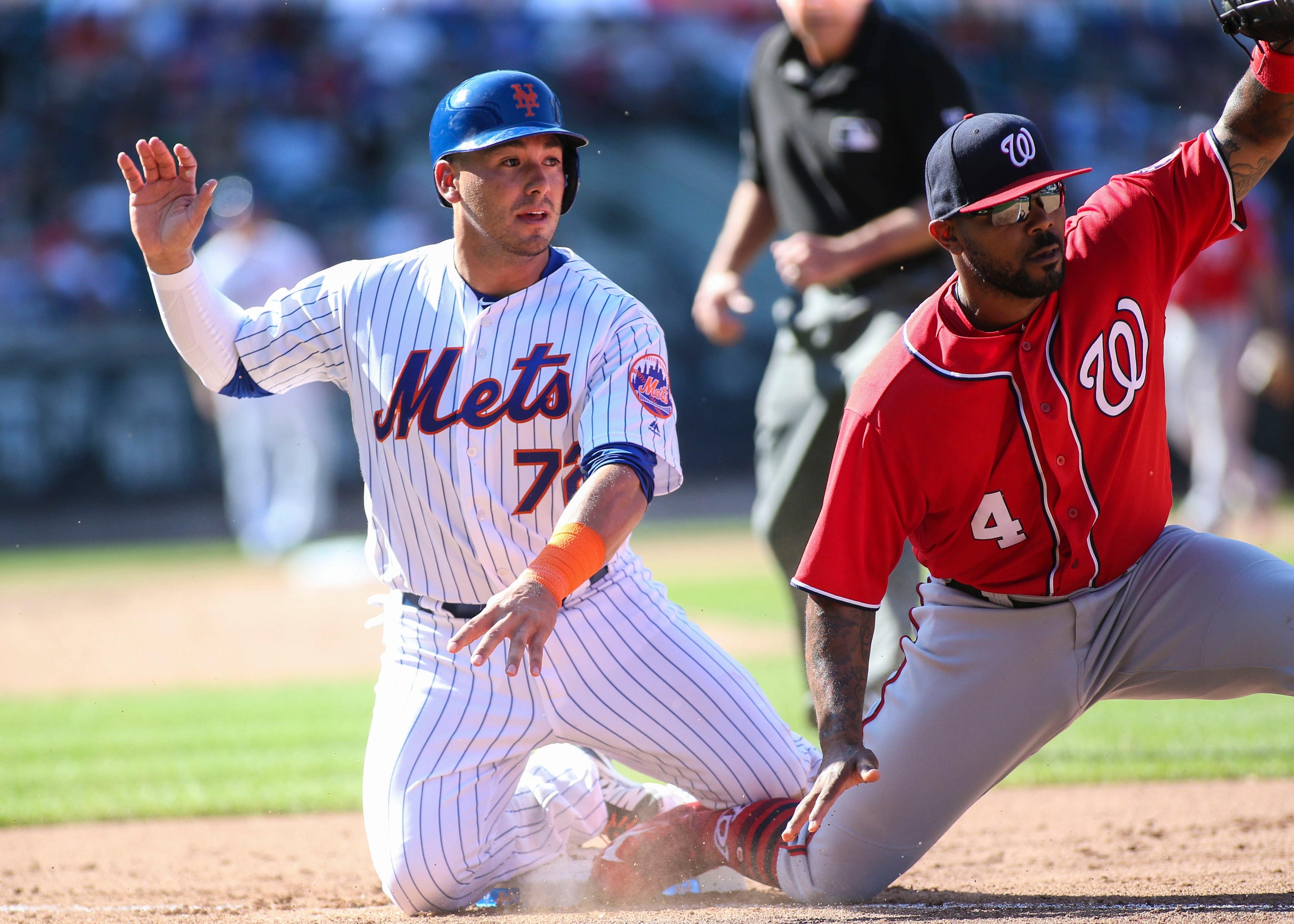 Sep 24, 2017; New York City, NY, USA; New York Mets third baseman Phil Evan (72) reacts to being picked off at first base by Washington Nationals first baseman Howie Kendrick (4) in the seventh inning at Citi Field. Mandatory Credit: Wendell Cruz-USA TODAY Sports / Wendell Cruz