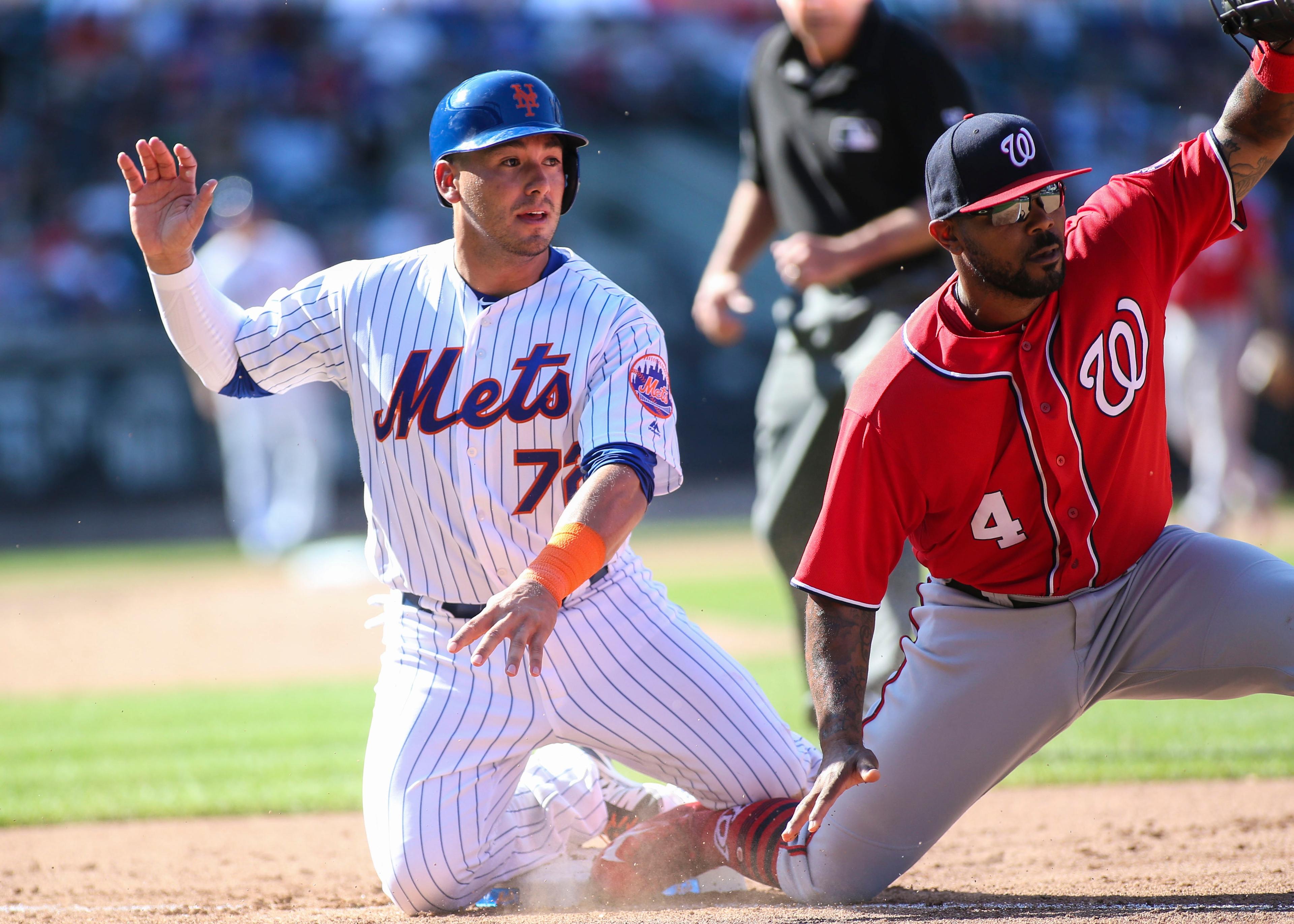 Sep 24, 2017; New York City, NY, USA; New York Mets third baseman Phil Evan (72) reacts to being picked off at first base by Washington Nationals first baseman Howie Kendrick (4) in the seventh inning at Citi Field. Mandatory Credit: Wendell Cruz-USA TODAY Sports