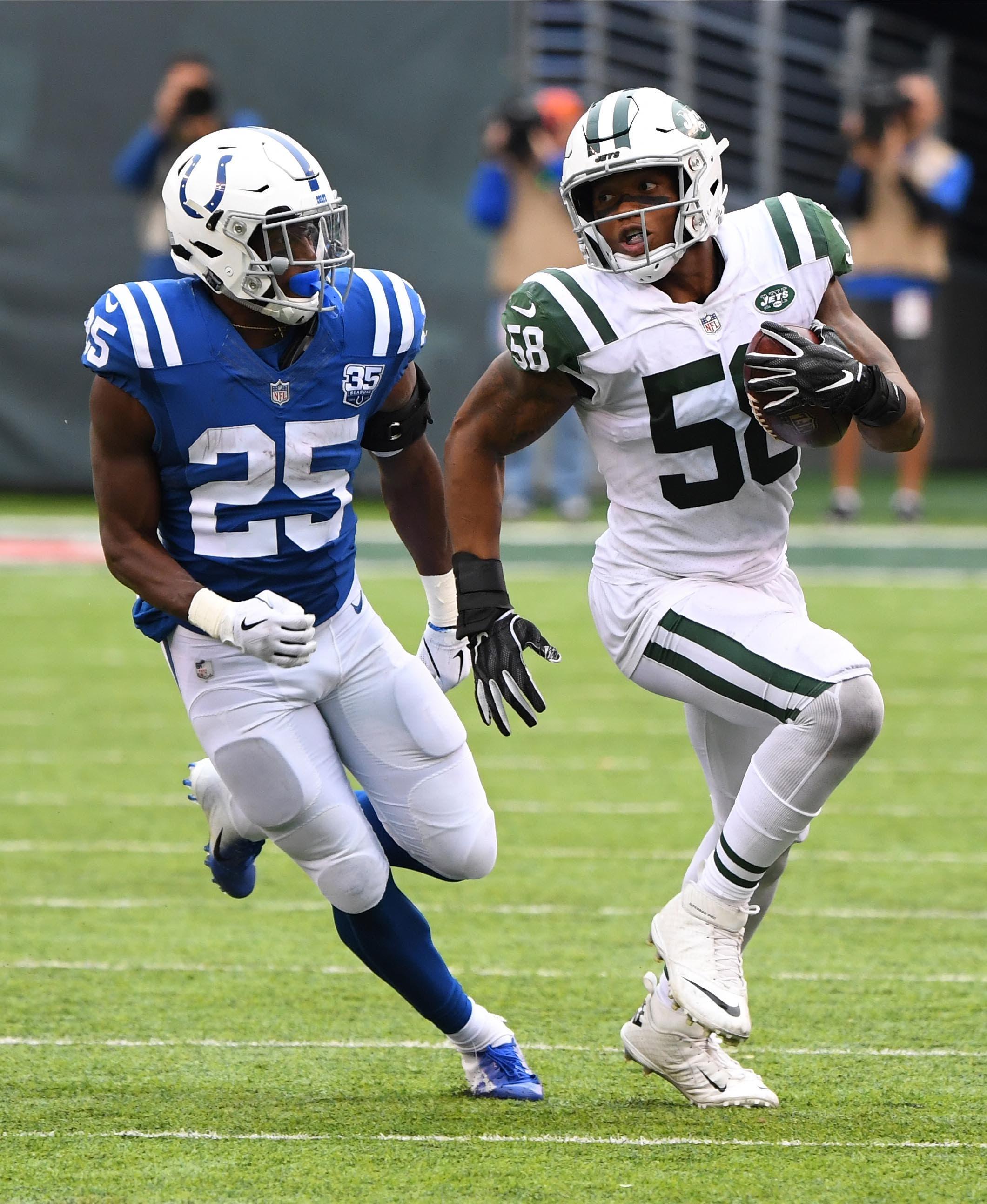 New York Jets linebacker Darron Lee is chased by Indianapolis Colts running back Marlon Mack after an interception in the fourth quarter at MetLife Stadium. / Robert Deutsch/USA TODAY Sports