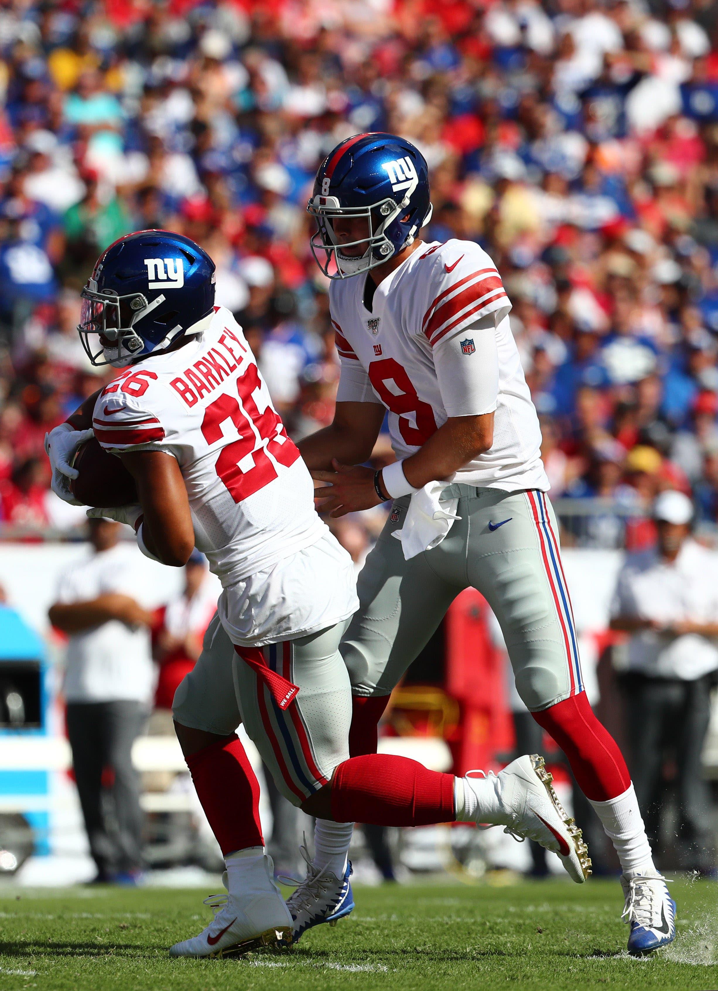 Sep 22, 2019; Tampa, FL, USA; New York Giants quarterback Daniel Jones (8) hands the ball off to New York Giants running back Saquon Barkley (26) during the first quarter at Raymond James Stadium. Mandatory Credit: Kim Klement-USA TODAY Sports / Kim Klement