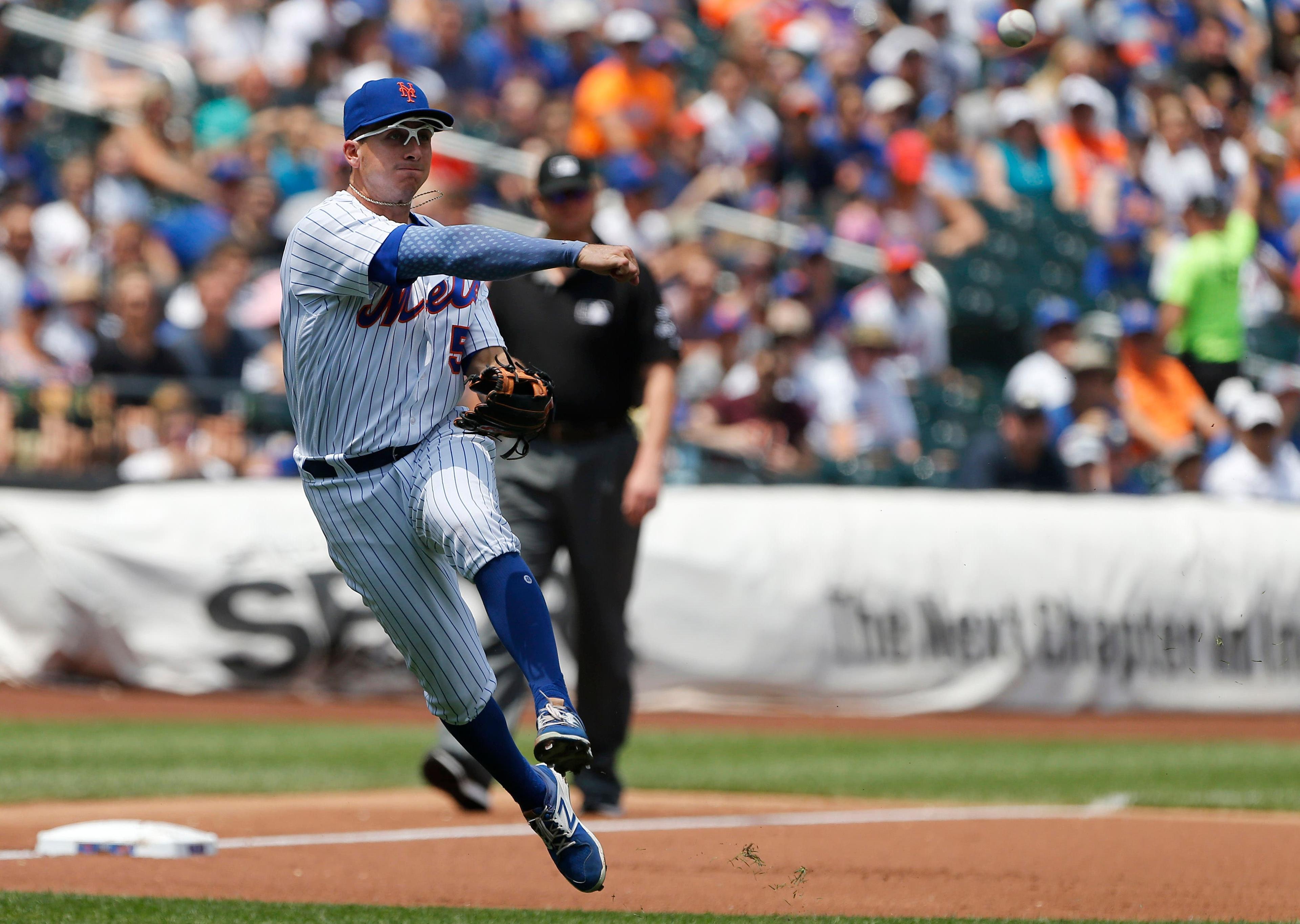 Jul 16, 2017; New York City, NY, USA; New York Mets third baseman T.J. Rivera (54) makes a throw to first base in the first inning against the Colorado Rockies at Citi Field. Mandatory Credit: Noah K. Murray-USA TODAY Sports / Noah K. Murray