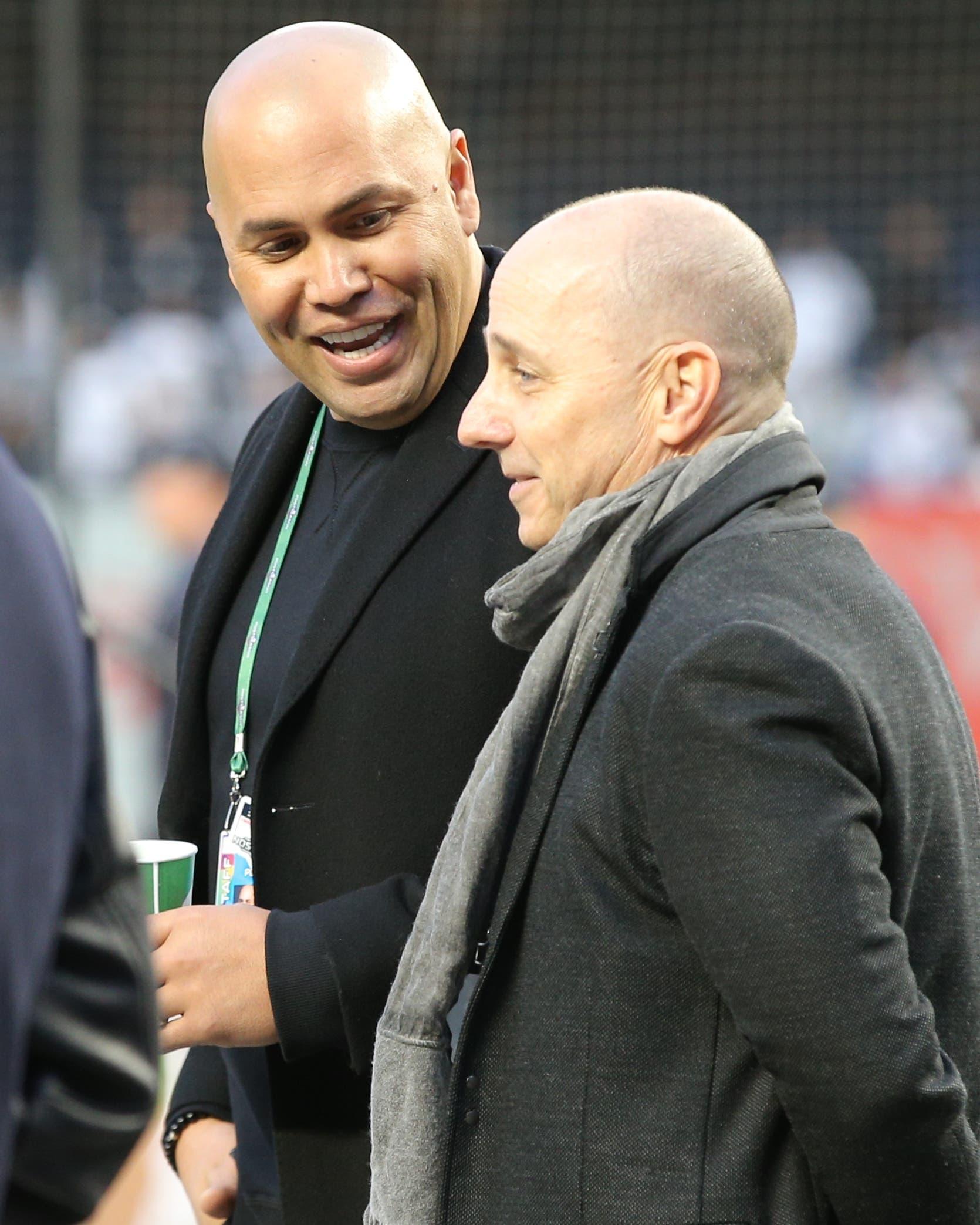 Oct 17, 2019; Bronx, NY, USA; New York Yankees former player Carlos Beltran (left) talks to general manager Brian Cashman during batting practice before game four of the 2019 ALCS playoff baseball series against the Houston Astros at Yankee Stadium. Mandatory Credit: Brad Penner-USA TODAY Sportsundefined