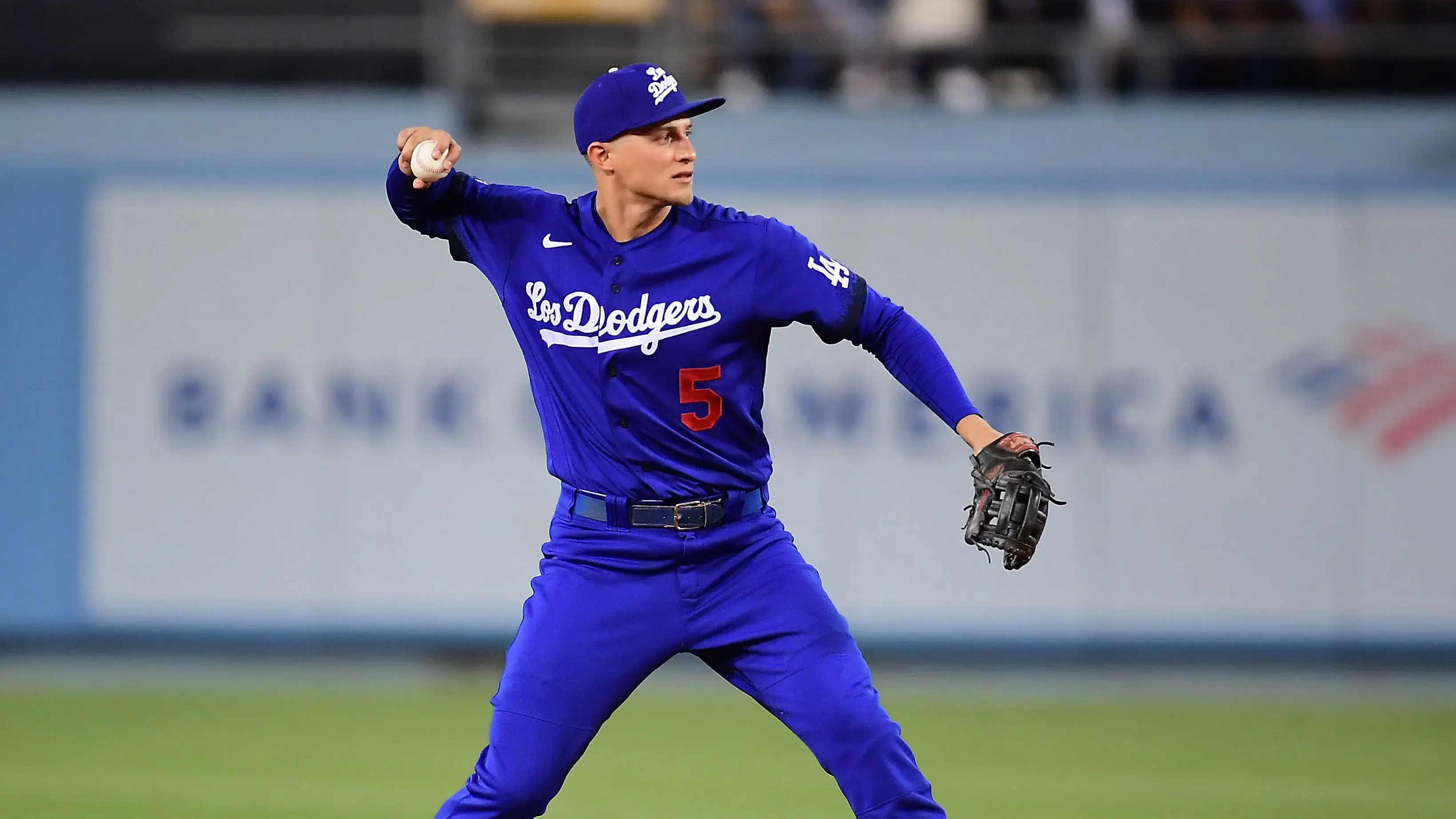 Los Angeles Dodgers shortstop Corey Seager (5) throws to first for the out against San Diego Padres left fielder Adam Frazier (12) during the third inning at Dodger Stadium. / Gary A. Vasquez/USA TODAY