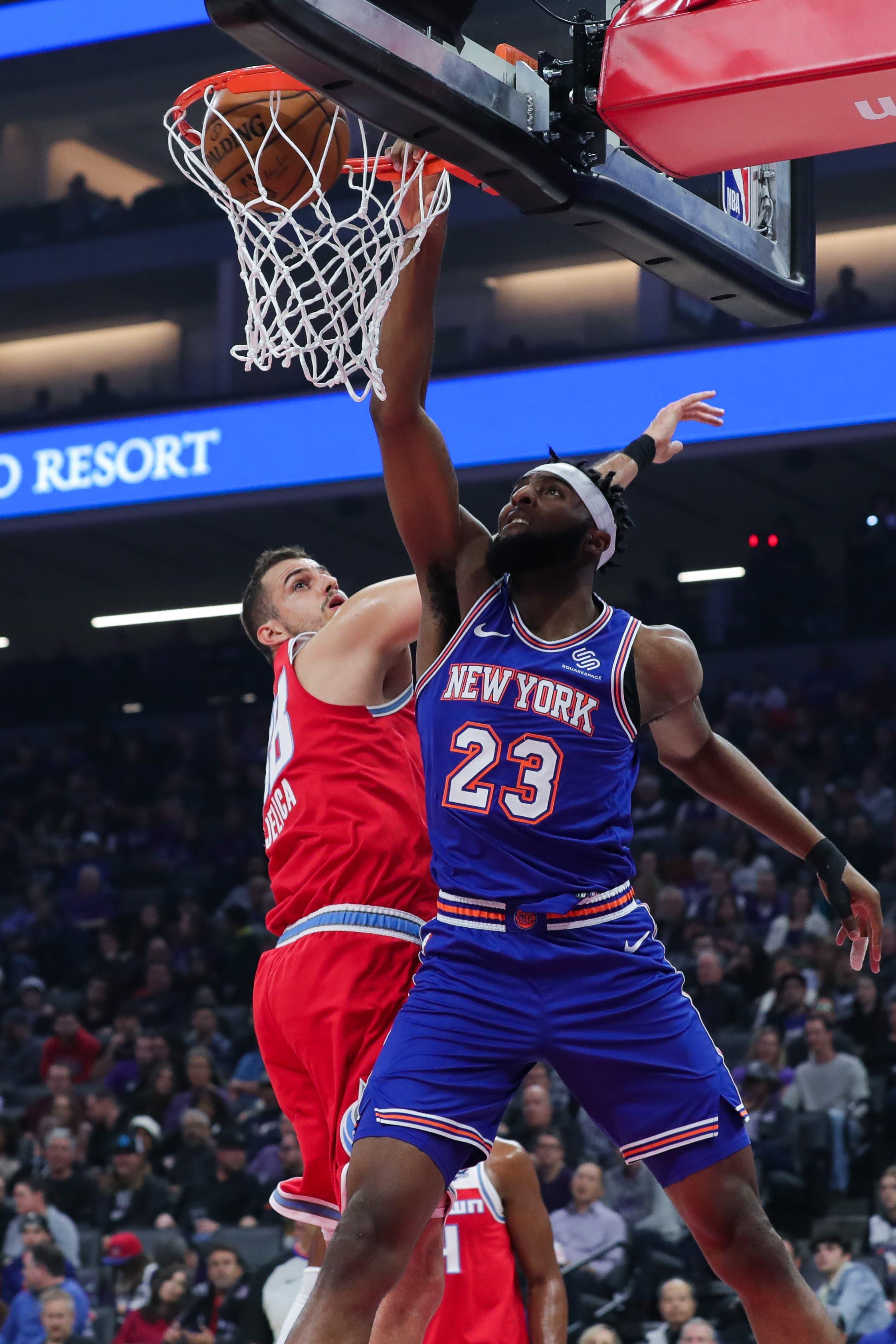 Dec 13, 2019; Sacramento, CA, USA; New York Knicks center Mitchell Robinson (23) dunks the ball over Sacramento Kings forward Nemanja Bjelica (88) during the first quarter at Golden 1 Center. Mandatory Credit: Sergio Estrada-USA TODAY Sports / Sergio Estrada