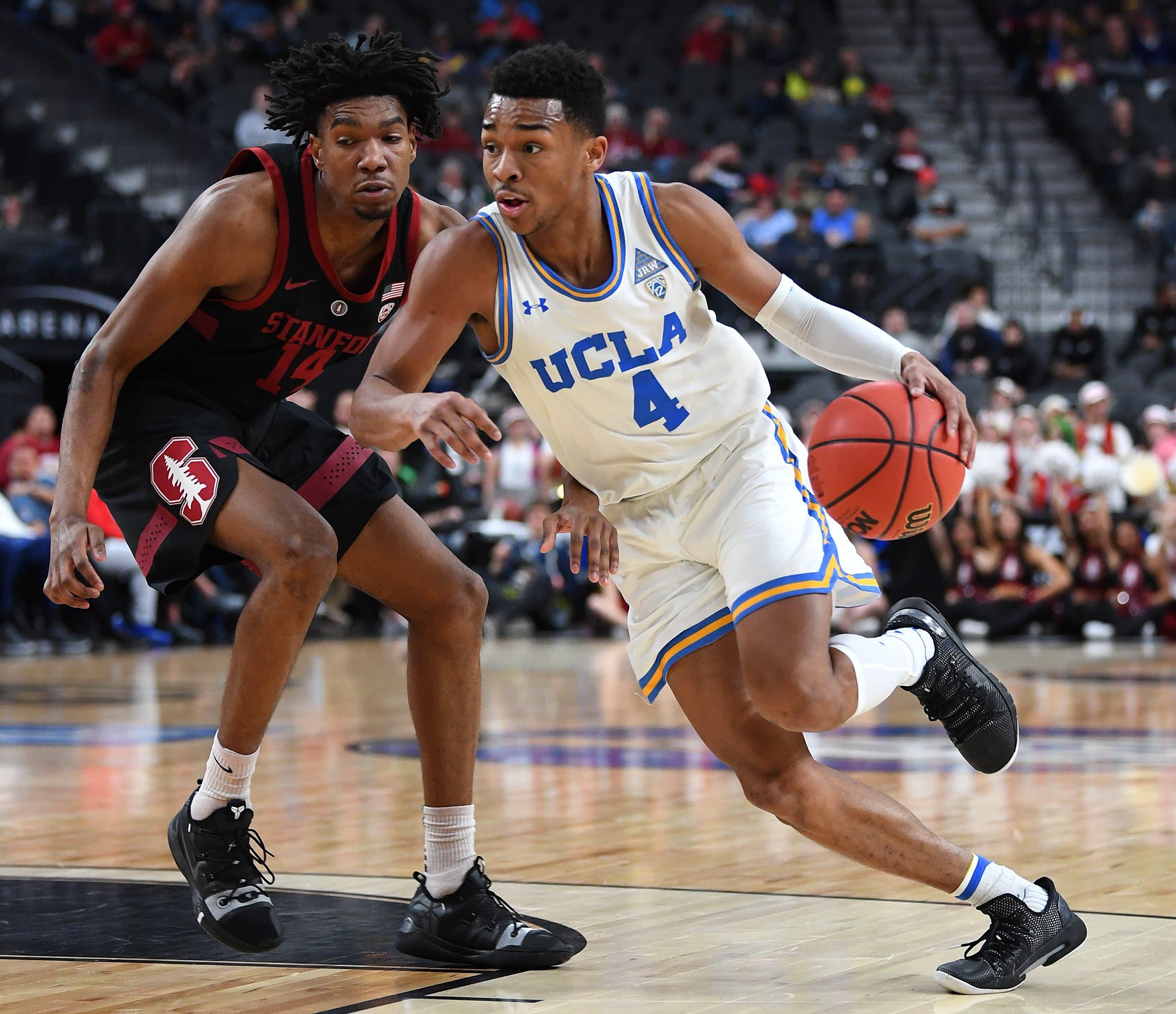 Mar 13, 2019; Las Vegas, NV, United States; UCLA Bruins guard Jaylen Hands (4) dribbles the ball past Stanford Cardinal guard Marcus Sheffield (14) during the second half of a Pac-12 conference tournament game at T-Mobile Arena. Mandatory Credit: Stephen R. Sylvanie-USA TODAY Sports / Stephen R. Sylvanie