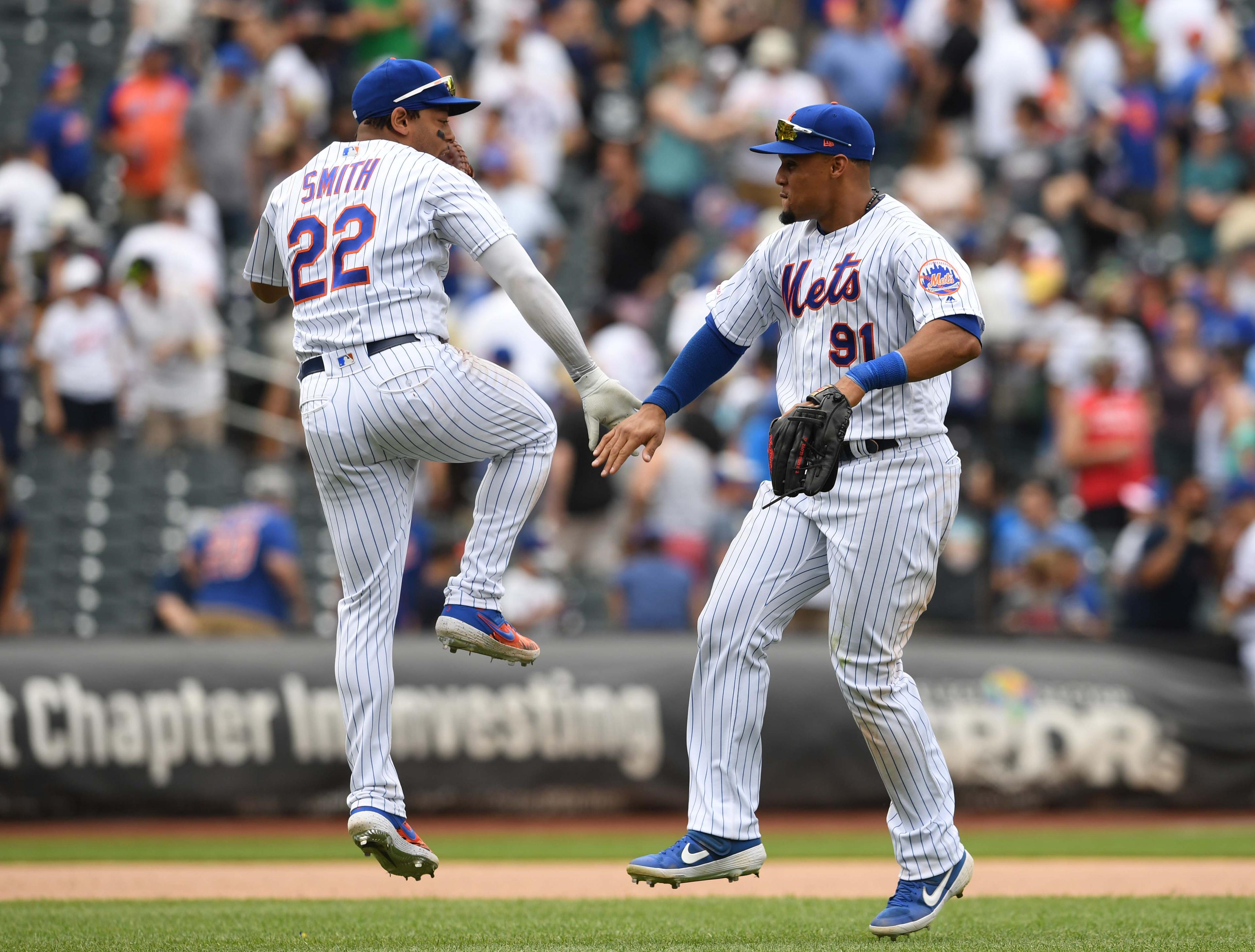 May 26, 2019; New York City, NY, USA; New York Mets first baseman Dominic Smith (22) high-fives right fielder Carlos Gomez (91) after the Mets win 4-3 during the ninth inning of a baseball game against the Detroit Tigers at Citi Field. Mandatory Credit: Sarah Stier-USA TODAY Sports