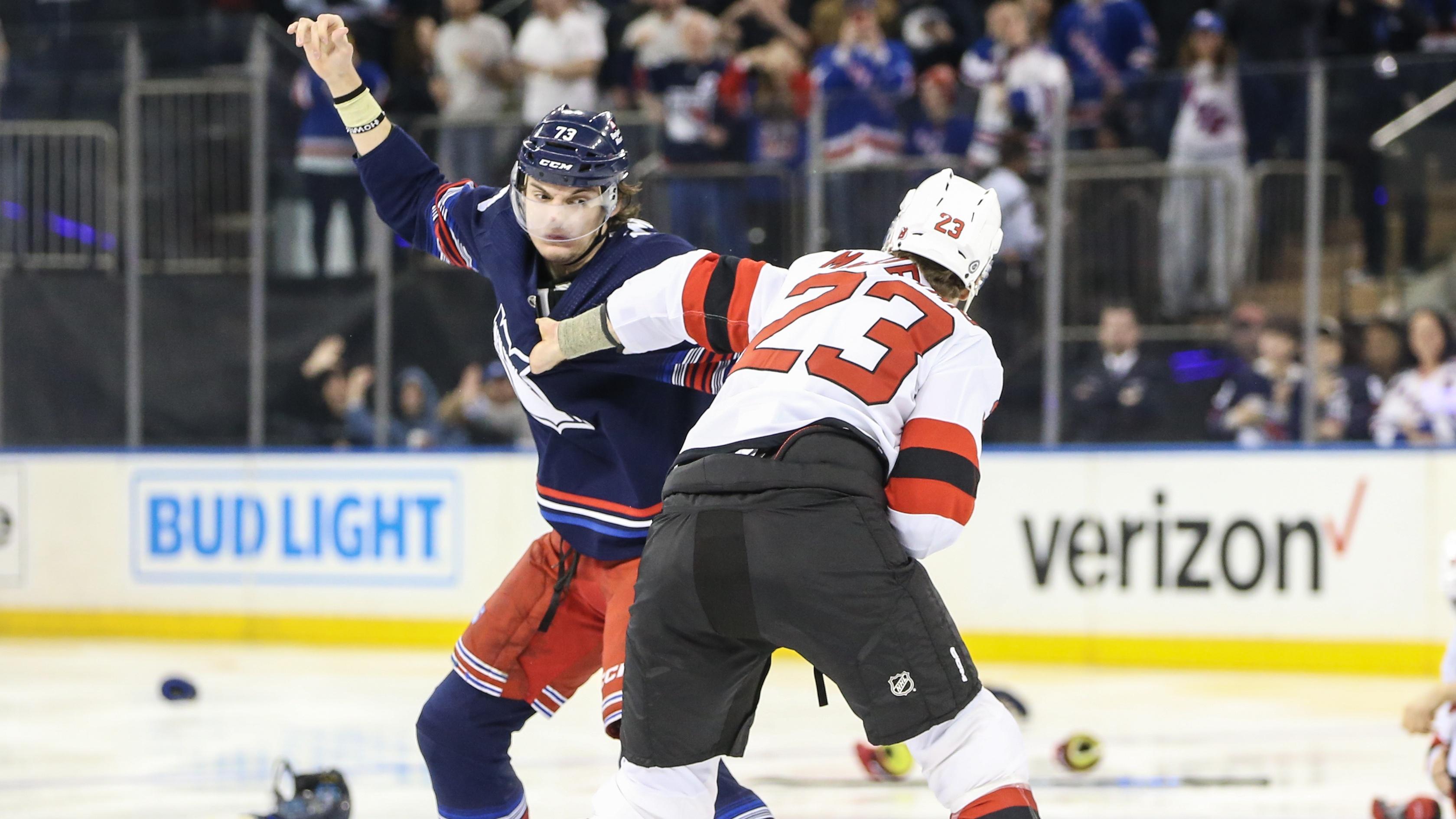 New York Rangers center Matt Rempe (73) and New Jersey Devils defenseman Kurtis MacDermid (23) fight at start of the 1st period at Madison Square Garden