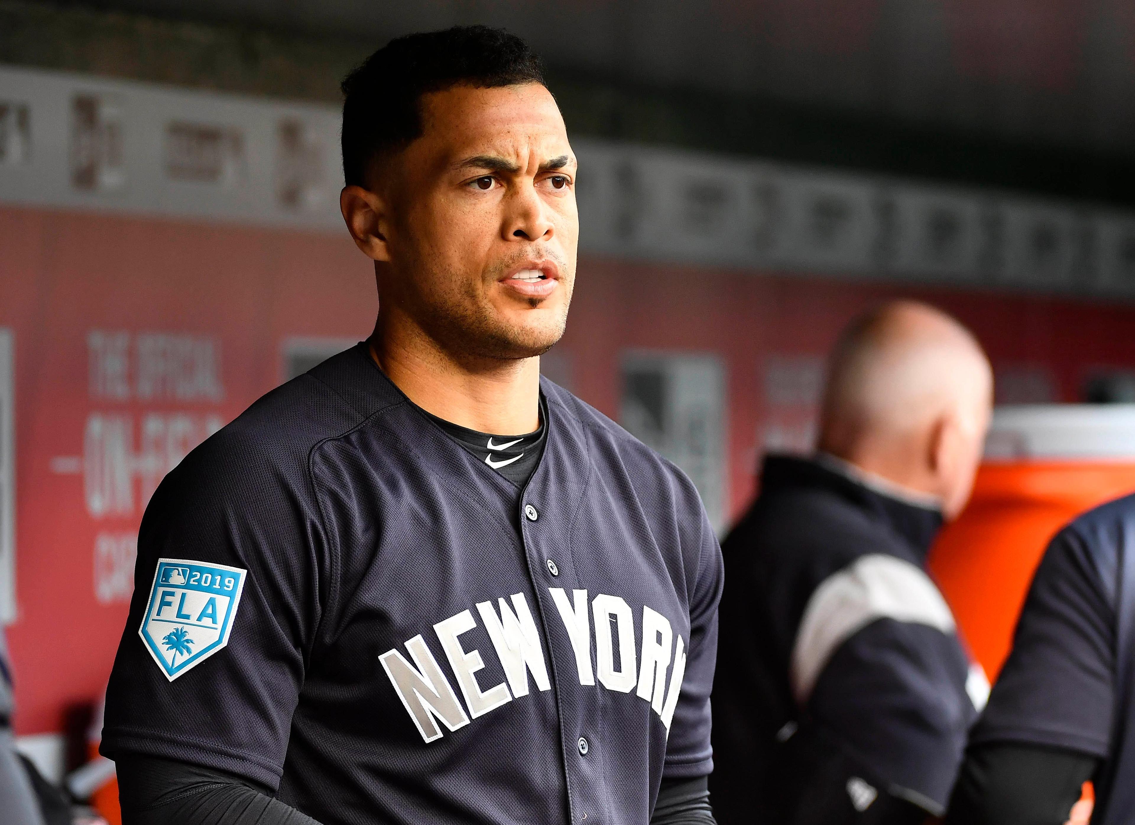 Mar 25, 2019; Washington, DC, USA; New York Yankees left fielder Giancarlo Stanton (27) looks on from the dugout against the Washington Nationals before the game at Nationals Park. Mandatory Credit: Brad Mills-USA TODAY Sports / Brad Mills