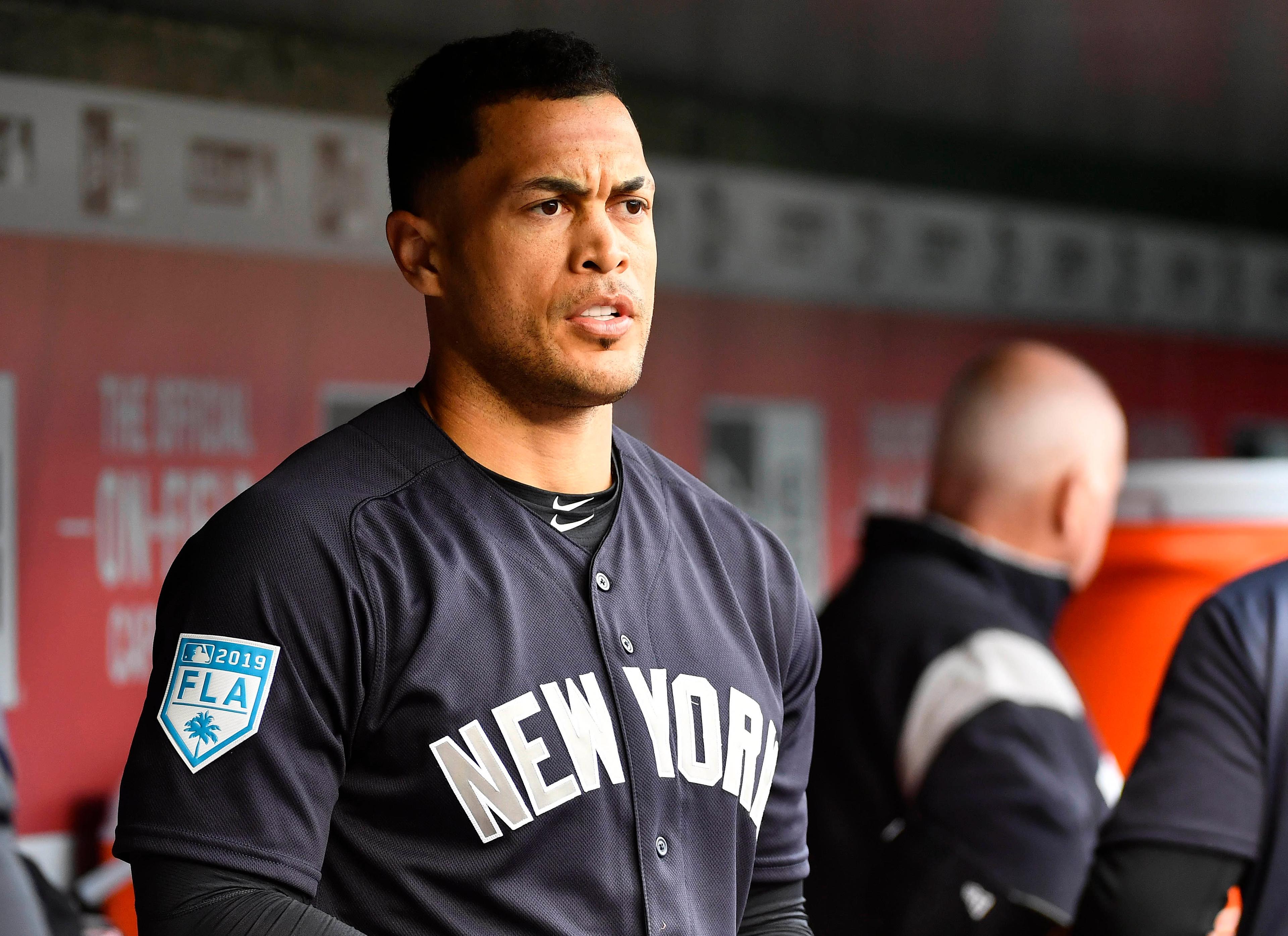 Mar 25, 2019; Washington, DC, USA; New York Yankees left fielder Giancarlo Stanton (27) looks on from the dugout against the Washington Nationals before the game at Nationals Park. Mandatory Credit: Brad Mills-USA TODAY Sports