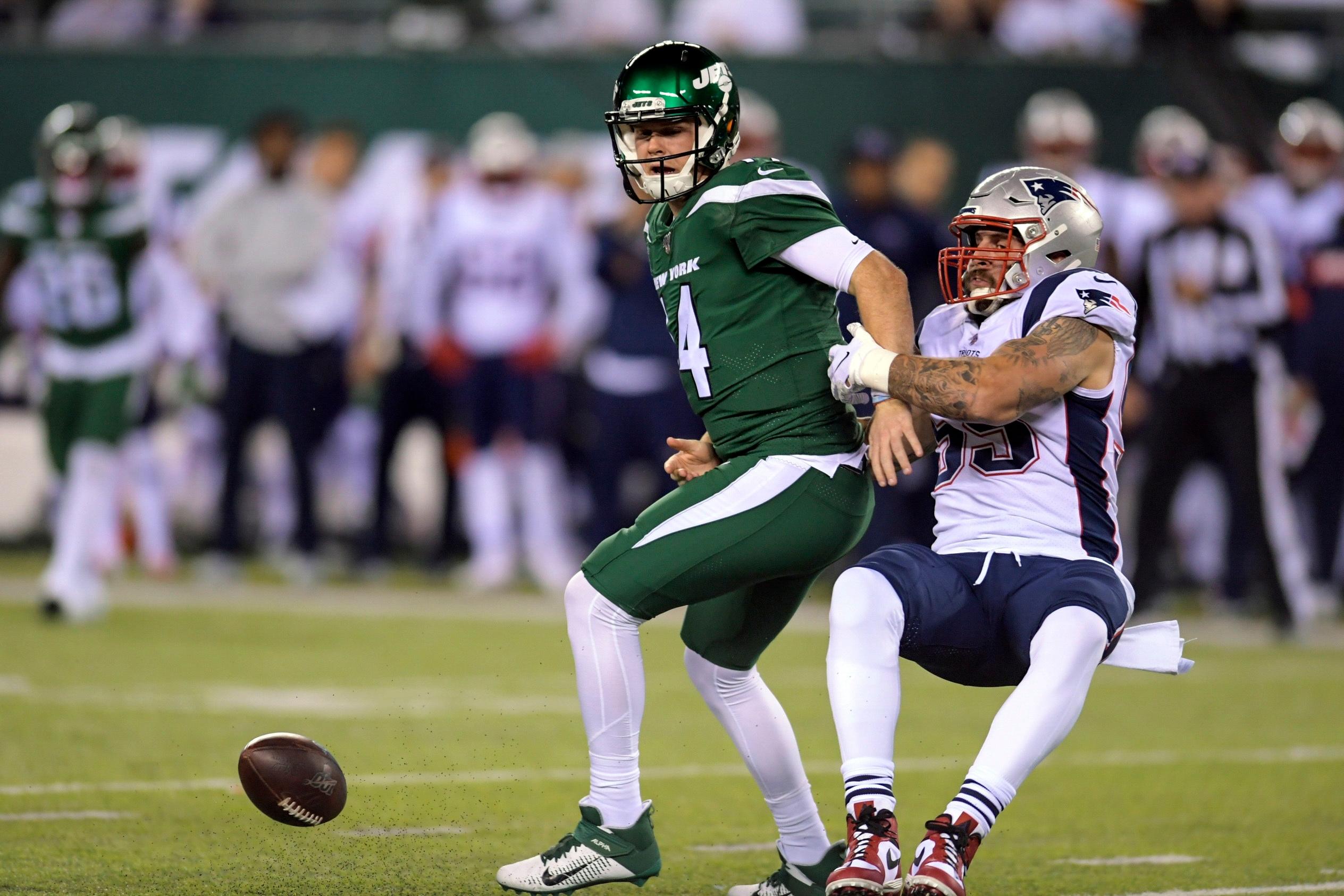 New York Jets quarterback Sam Darnold, right, loses control of the ball as he is sacked by New England Patriots' John Simon (55) during the first half of an NFL football game Monday, Oct. 21, 2019, in East Rutherford, N.J. (AP Photo/Bill Kostroun)