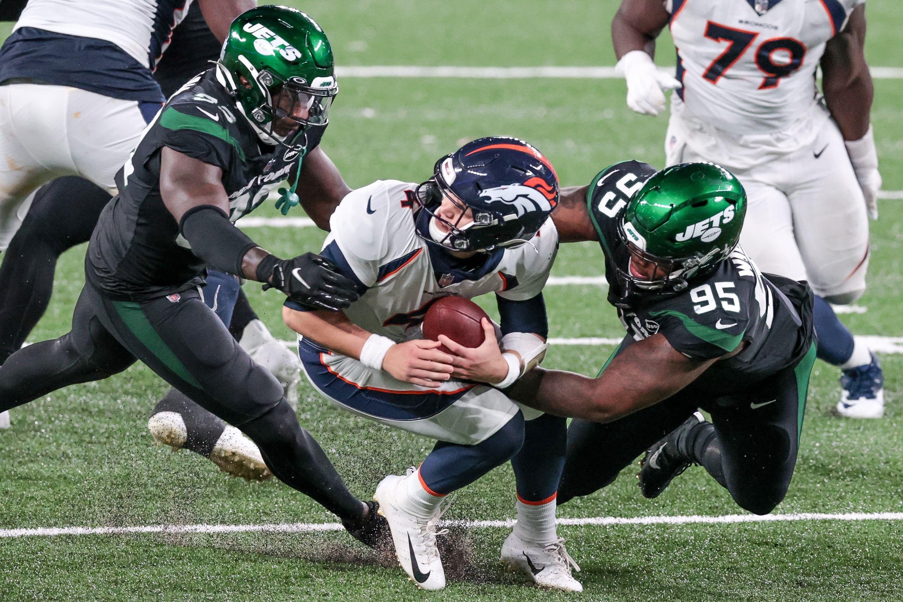 New York Jets defensive tackle Quinnen Williams (95) tackles Denver Broncos quarterback Brett Rypien (4) by the facemask with cornerback Pierre Desir (35) during the second half at MetLife Stadium. / Vincent Carchietta - USA TODAY Sports