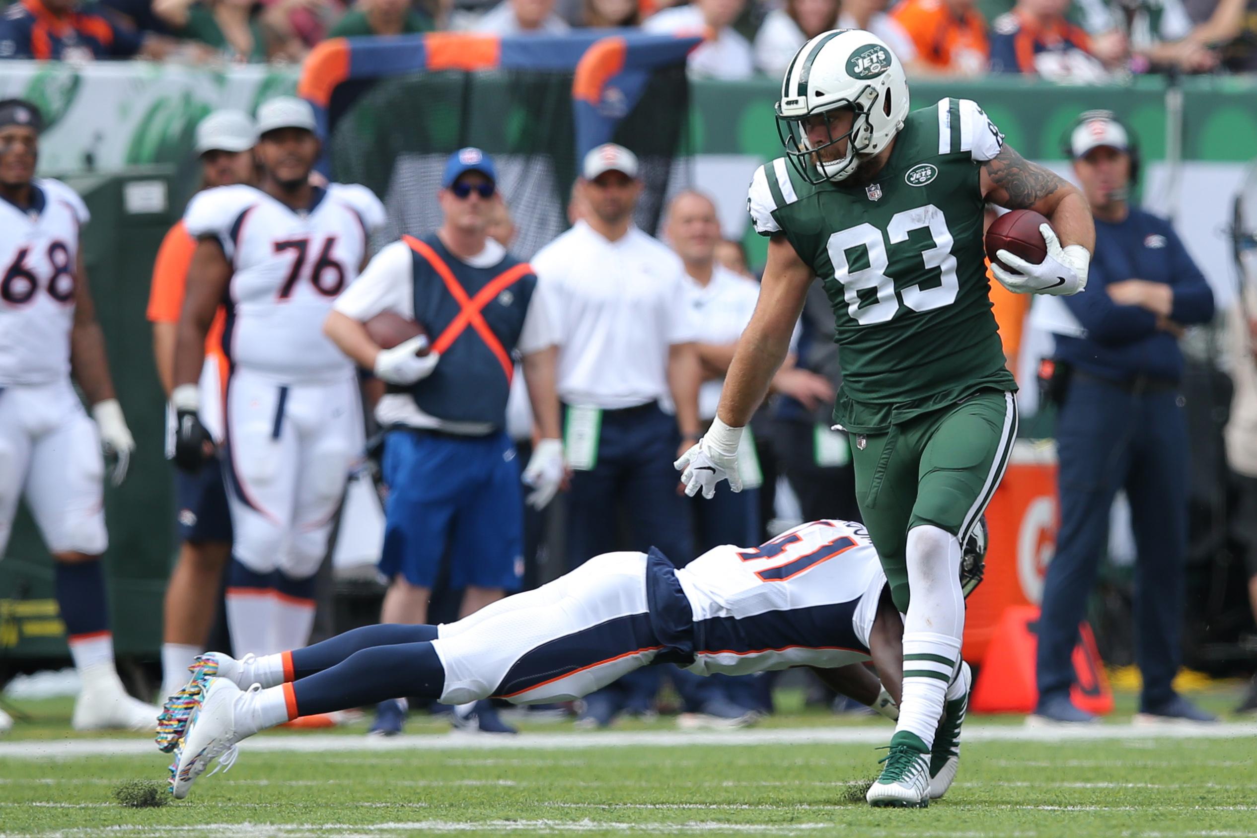 Oct 7, 2018; East Rutherford, NJ, USA; New York Jets tight end Eric Tomlinson (83) carries the ball past Denver Broncos cornerback Isaac Yiadom (41) during the second quarter at MetLife Stadium. Mandatory Credit: Brad Penner-USA TODAY Sports