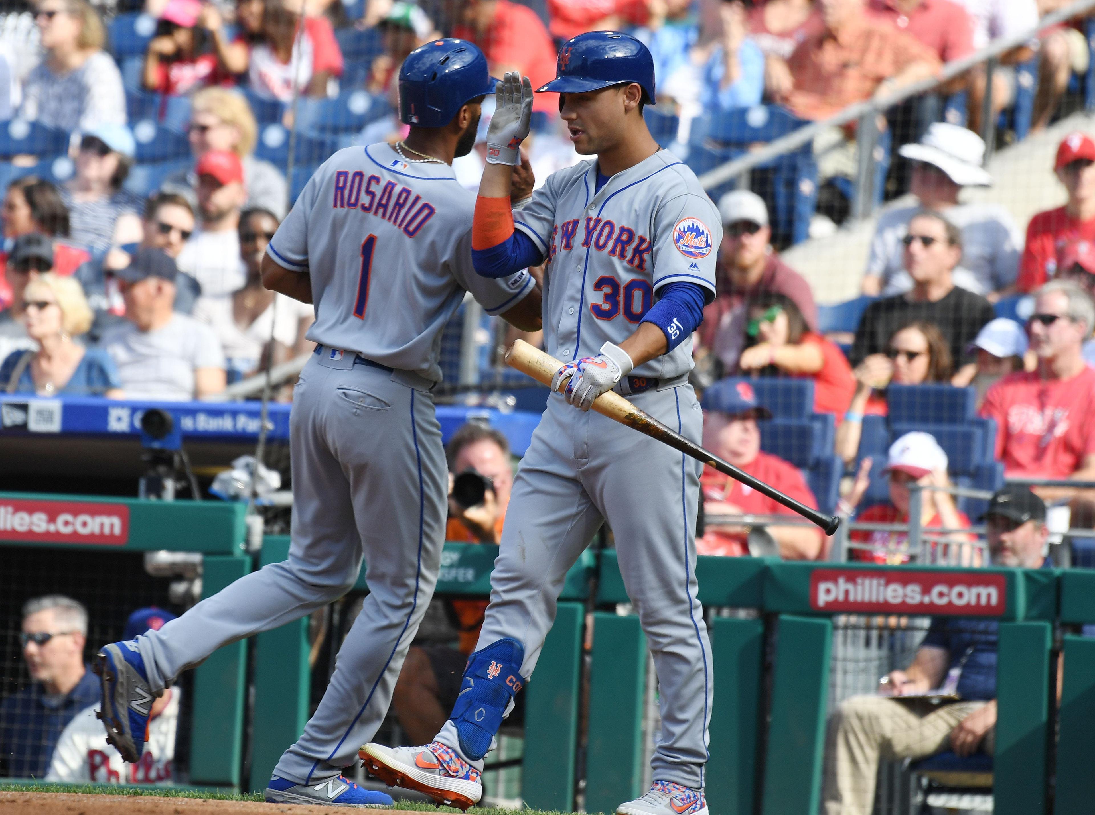 Aug 31, 2019; Philadelphia, PA, USA; New York Mets shortstop Amed Rosario (1) is congratulated by right fielder Michael Conforto (30) after scoring a run in the first inning against the New York Mets at Citizens Bank Park. Mandatory Credit: James Lang-USA TODAY Sports / James Lang