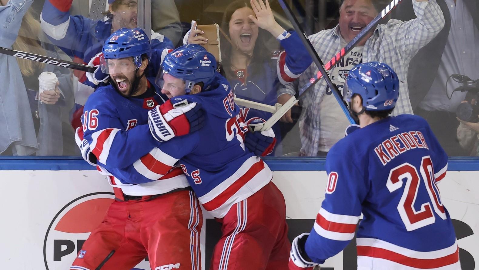 New York Rangers center Vincent Trocheck (16) celebrates his game winning goal against the Carolina Hurricanes with defenseman Adam Fox (23) and left wing Chris Kreider (20) during the second overtime of game two of the second round of the 2024 Stanley Cup Playoffs at Madison Square Garden. / Brad Penner-USA TODAY Sports