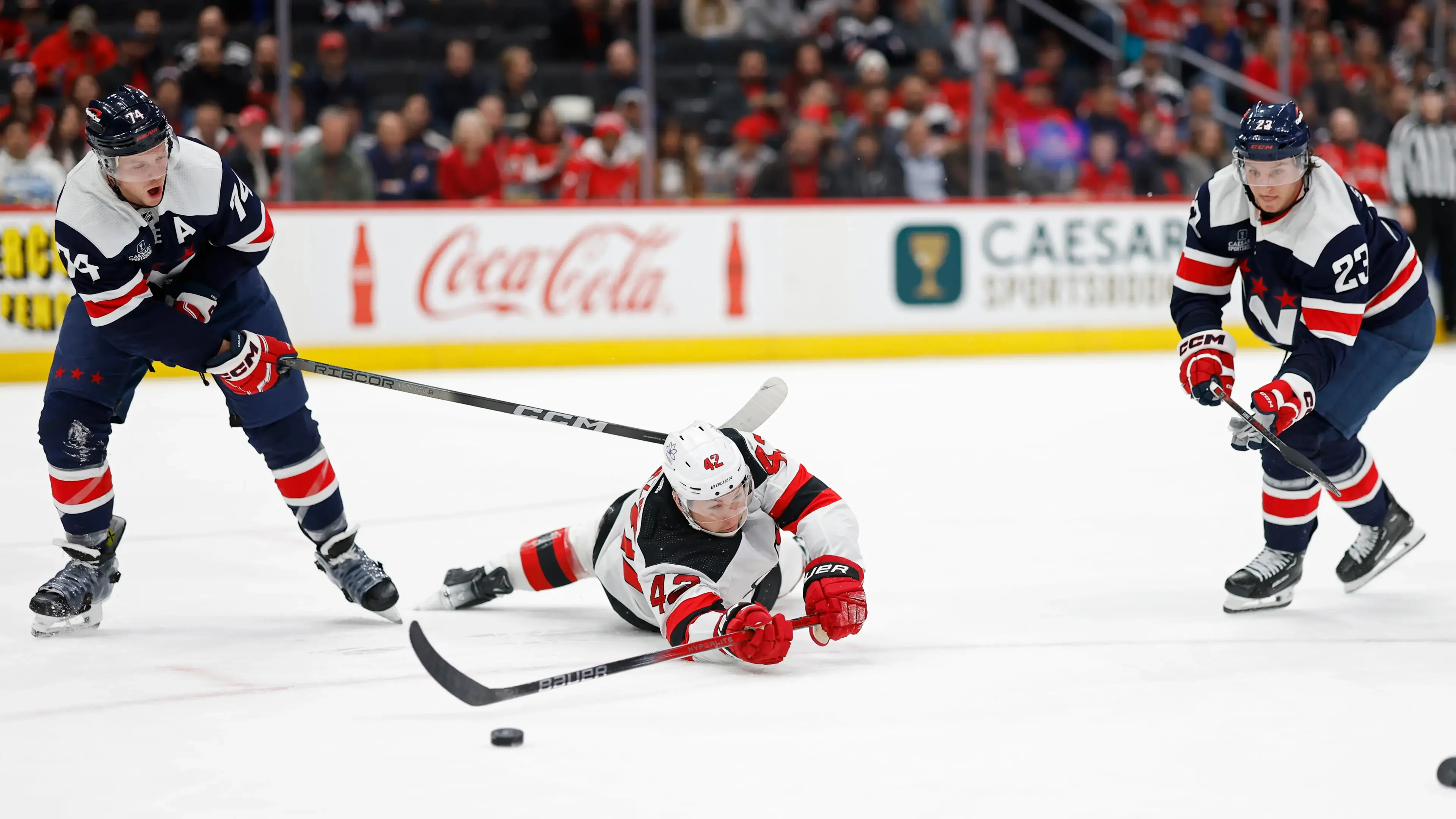 New Jersey Devils center Curtis Lazar (42) battles for the puck with Washington Capitals defenseman John Carlson (74) and Capitals center Michael Sgarbossa (23) in the first period at Capital One Arena. / Geoff Burke-USA TODAY Sports