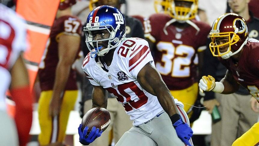 Sep 25, 2014; Landover, MD, USA; New York Giants cornerback Prince Amukamara (20) runs the ball after an interception against the Washington Redskins during the second half at FedEx Field.