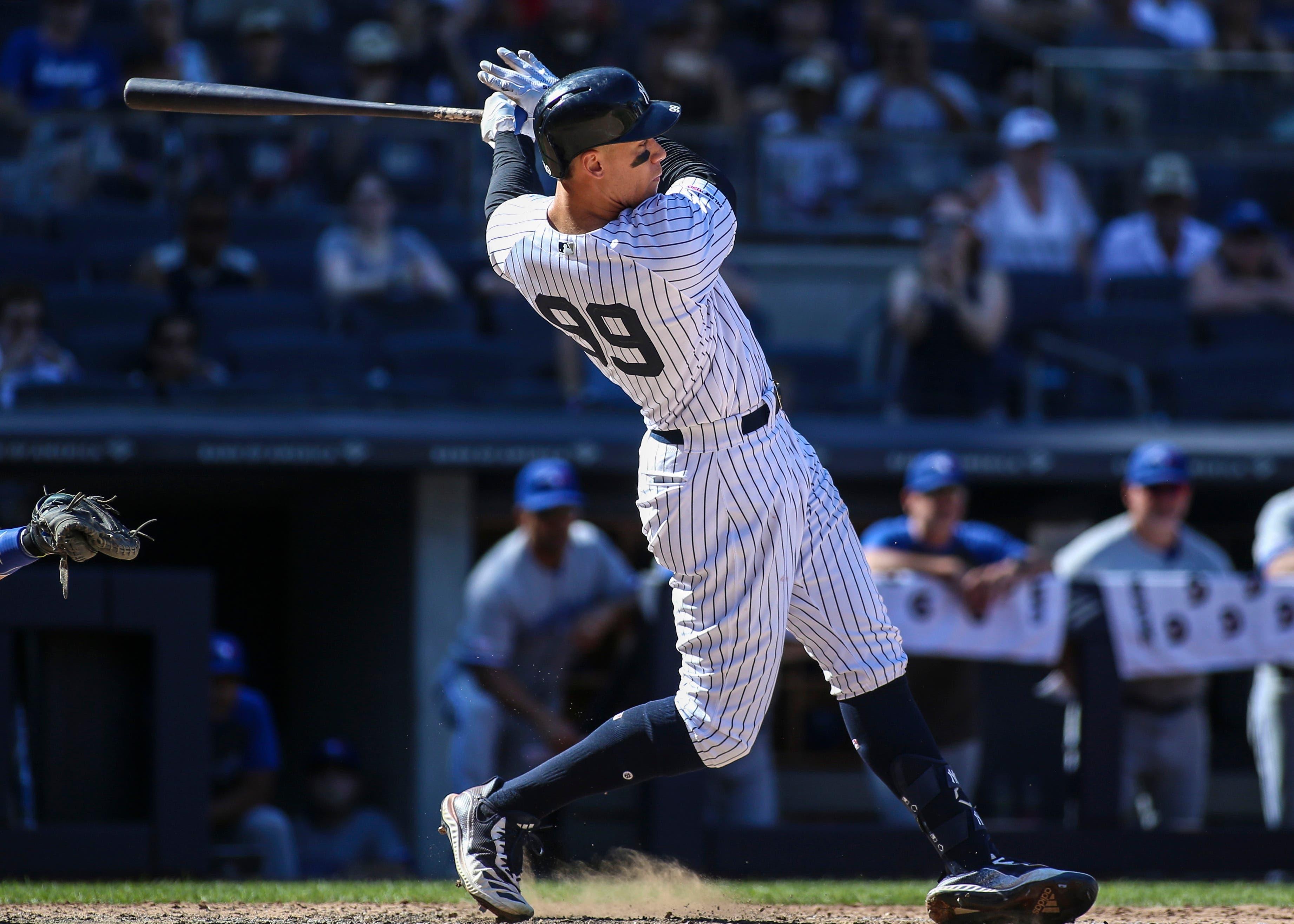 Jul 13, 2019; Bronx, NY, USA; New York Yankees right fielder Aaron Judge (99) hits an RBI single against the Toronto Blue Jays in the ninth inning at Yankee Stadium. Mandatory Credit: Wendell Cruz-USA TODAY Sports / Wendell Cruz