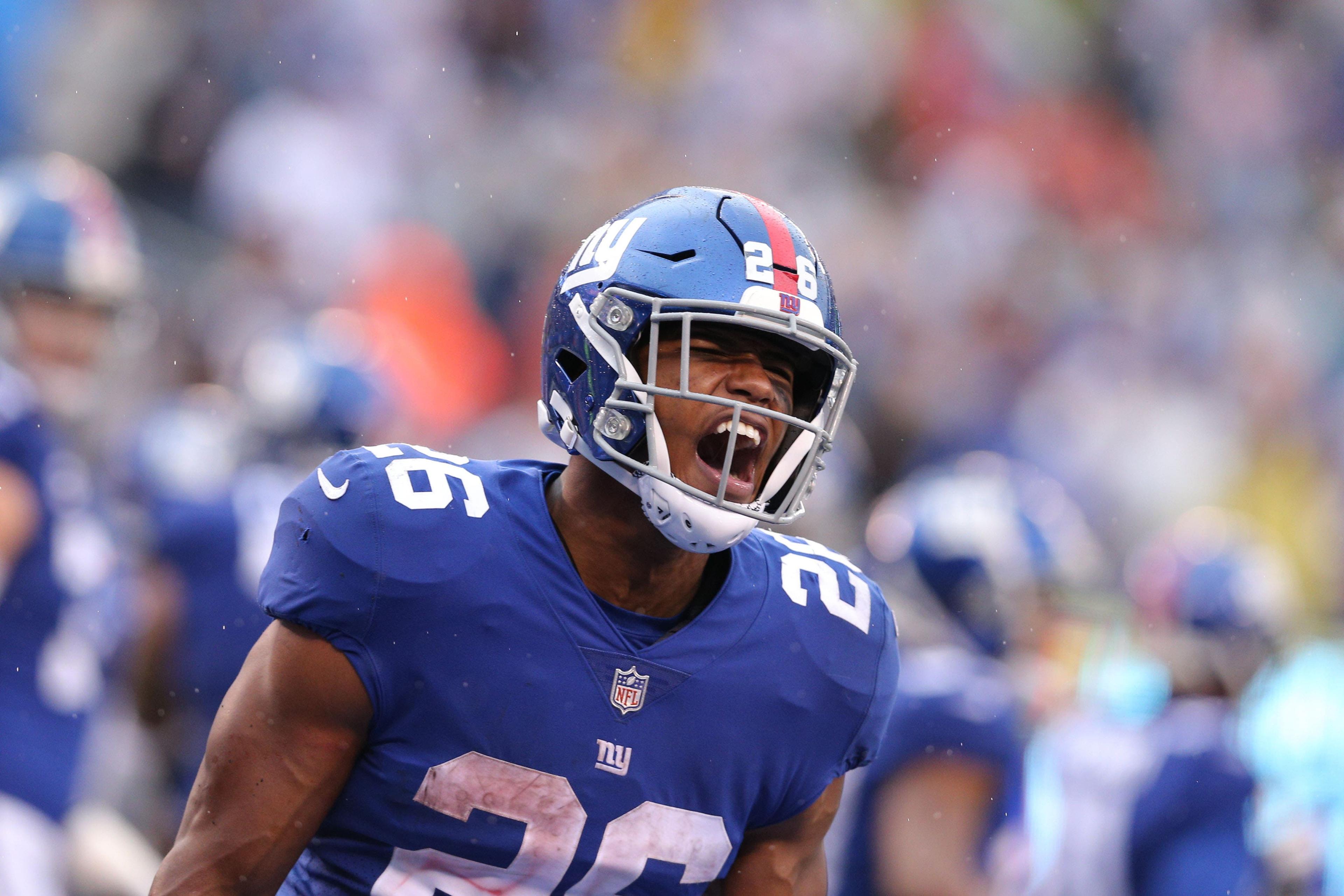 Sep 9, 2018; East Rutherford, NJ, USA; New York Giants running back Saquon Barkley (26) celebrates his touchdown against the Jacksonville Jaguars during the fourth quarter at MetLife Stadium. The touchdown was the first of his NFL career. Mandatory Credit: Brad Penner-USA TODAY Sports / Brad Penner