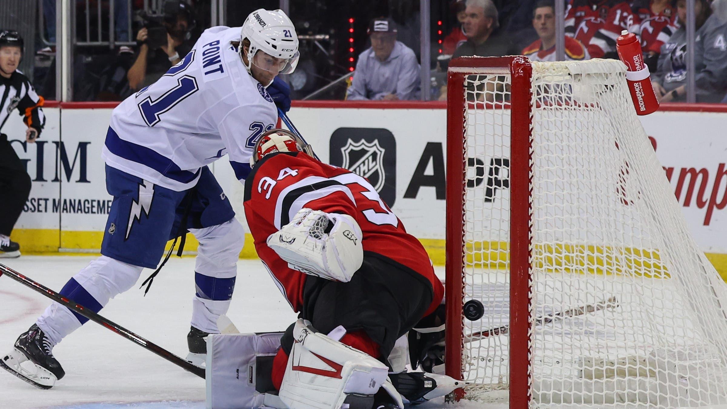 Tampa Bay Lightning center Brayden Point (21) scores a goal on New Jersey Devils goaltender Jake Allen (34) during the first period at Prudential Center