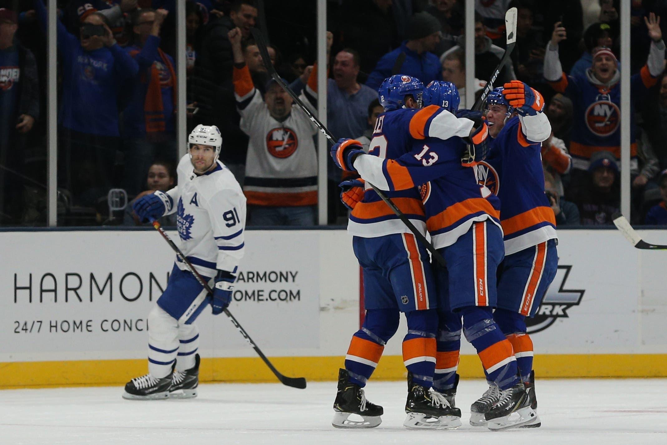 Feb 28, 2019; Brooklyn, NY, USA; New York Islanders left wing Anthony Beauvillier (18) celebrates his goal against the Toronto Maple Leafs with teammates in front of Toronto Maple Leafs center John Tavares (91) during the first period at the Nassau Veterans Memorial Coliseum. Mandatory Credit: Brad Penner-USA TODAY Sports / Brad Penner