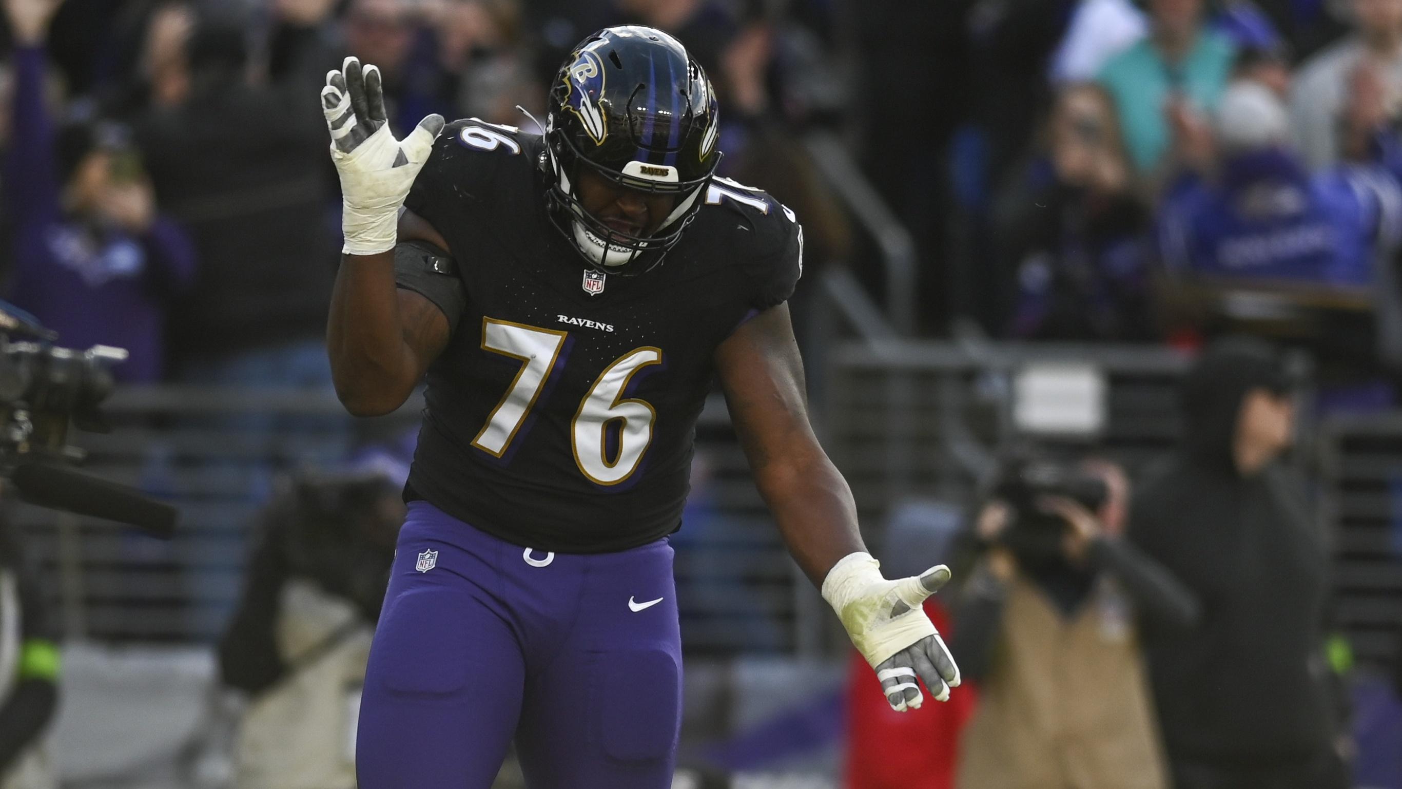 Baltimore Ravens guard John Simpson (76) reacts after running back Gus Edwards (35) touchdown against the Miami Dolphins during the first half at M&T Bank Stadium
