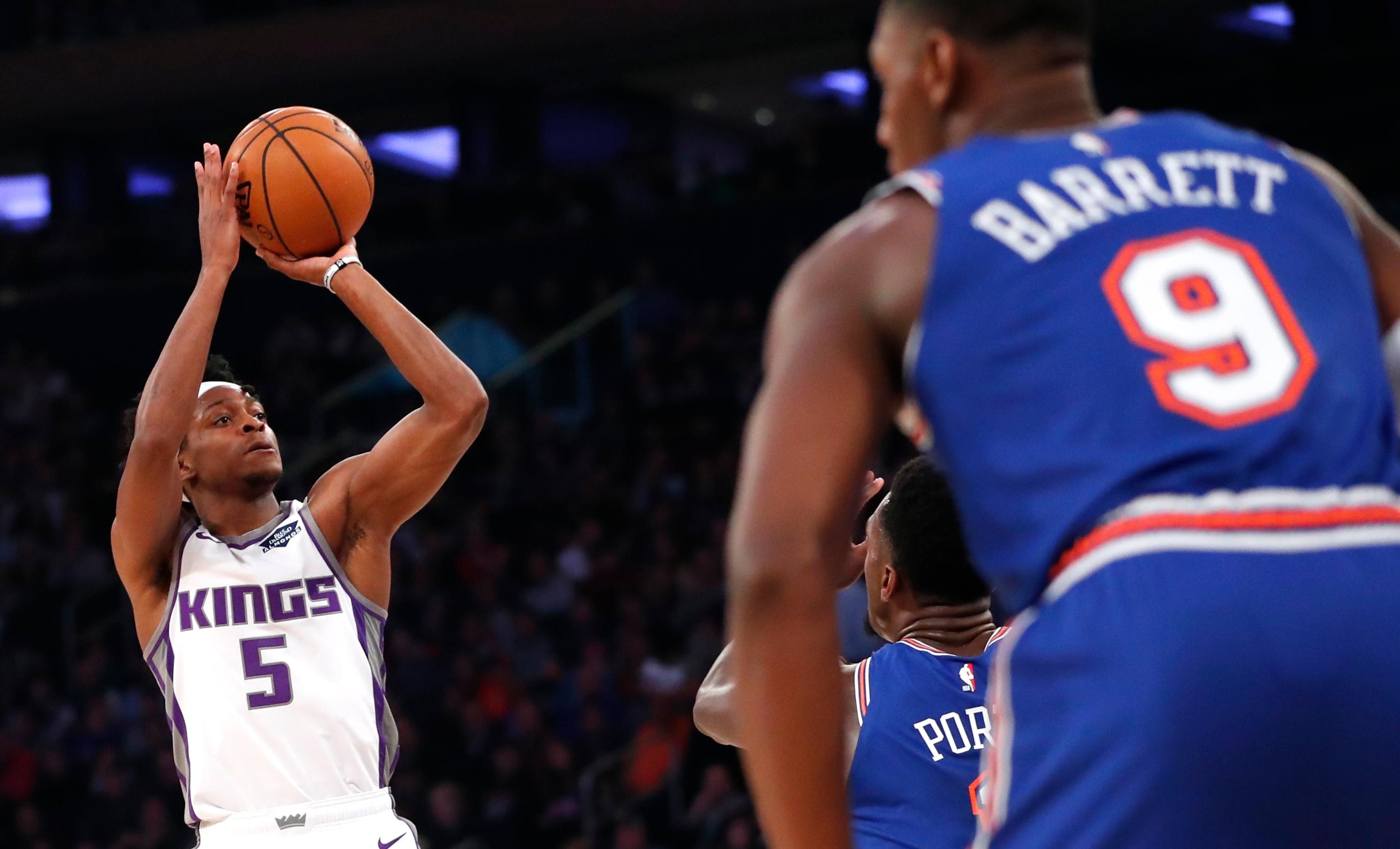 Nov 3, 2019; New York, NY, USA; Sacramento Kings guard De'Aaron Fox (5) shoots against New York Knicks defenders during the first half at Madison Square Garden. Mandatory Credit: Noah K. Murray-USA TODAY Sports