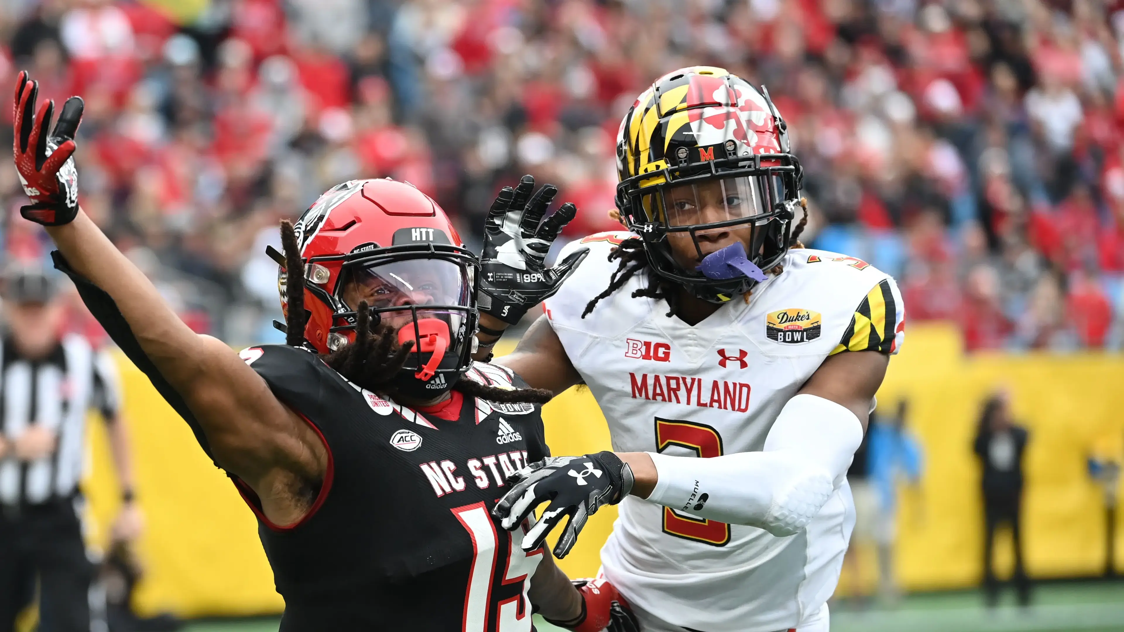 Dec 30, 2022; Charlotte, NC, USA; North Carolina State Wolfpack wide receiver Keyon Lesane (15) reaches for a pass as Maryland Terrapins defensive back Deonte Banks (3) defends in the fourth quarter in the 2022 Duke's Mayo Bowl at Bank of America Stadium. / Bob Donnan-USA TODAY Sports